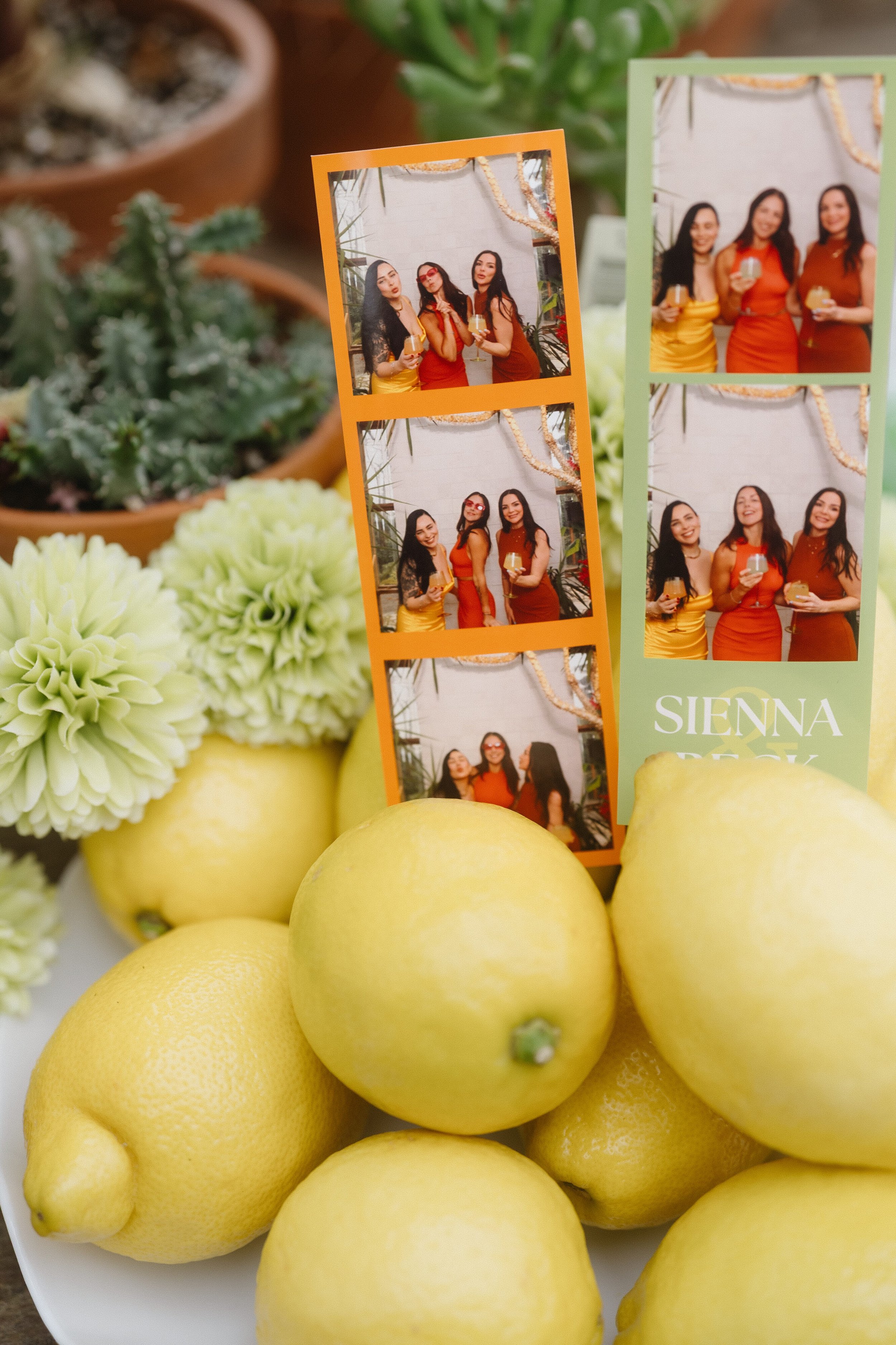 Vintage photo booth strips with custom overlay displayed in citrus-themed wedding decor