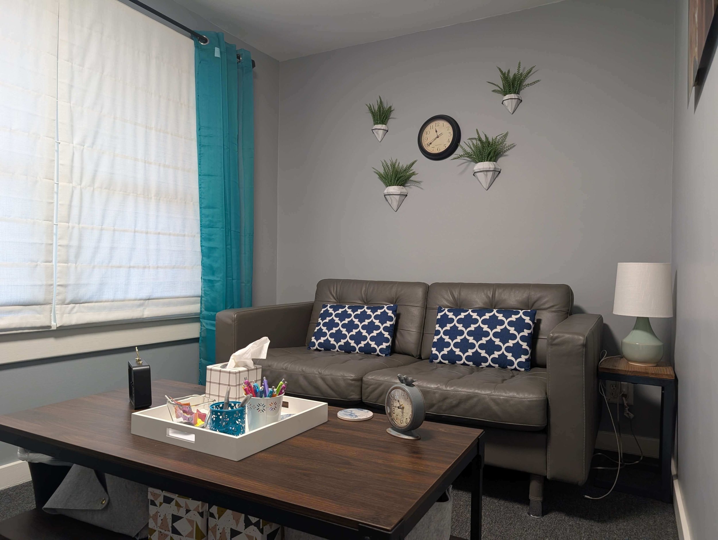 Comfortable counseling office with couch, chair, and natural light