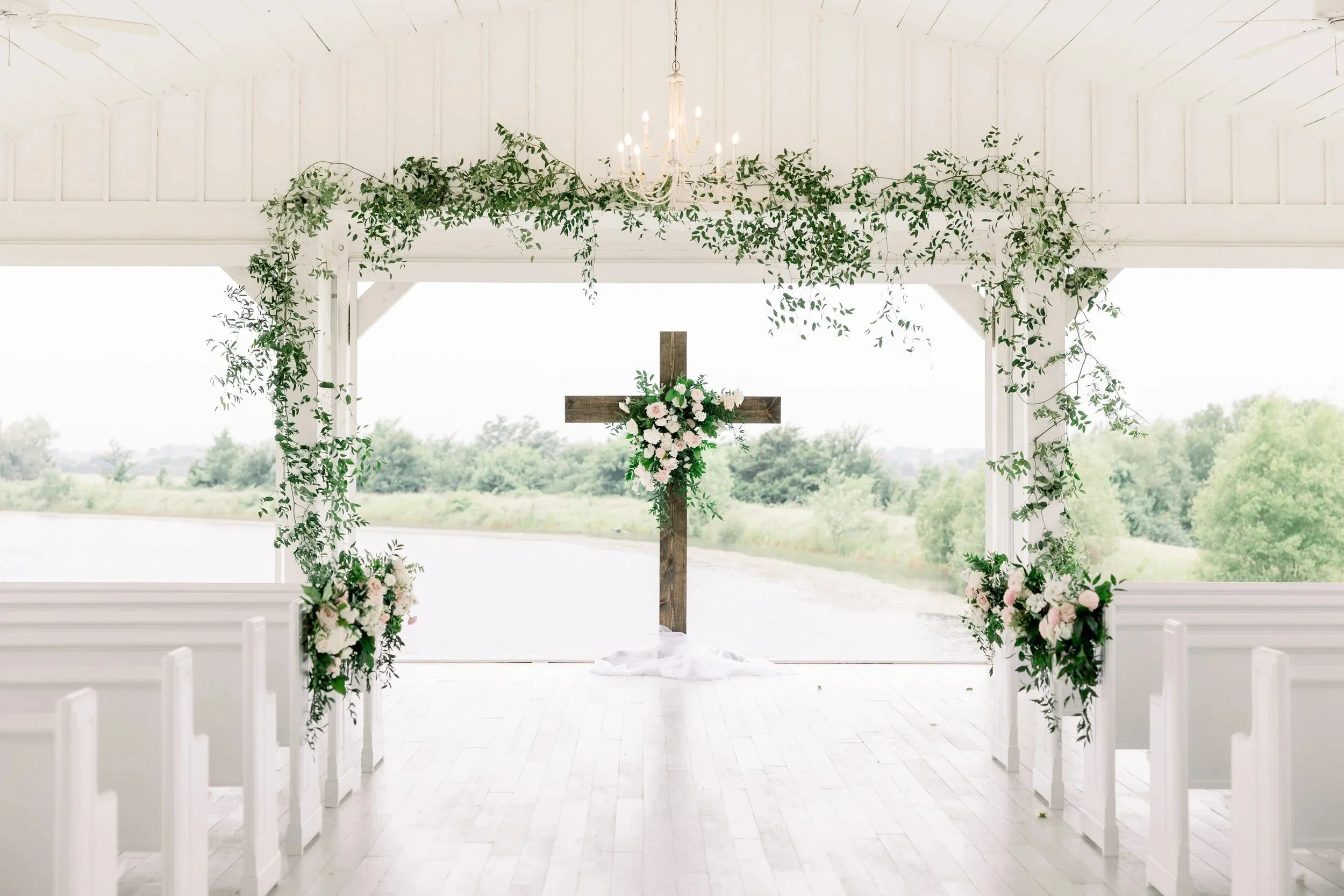 Ceremony arch with white florals by Haute Poppies