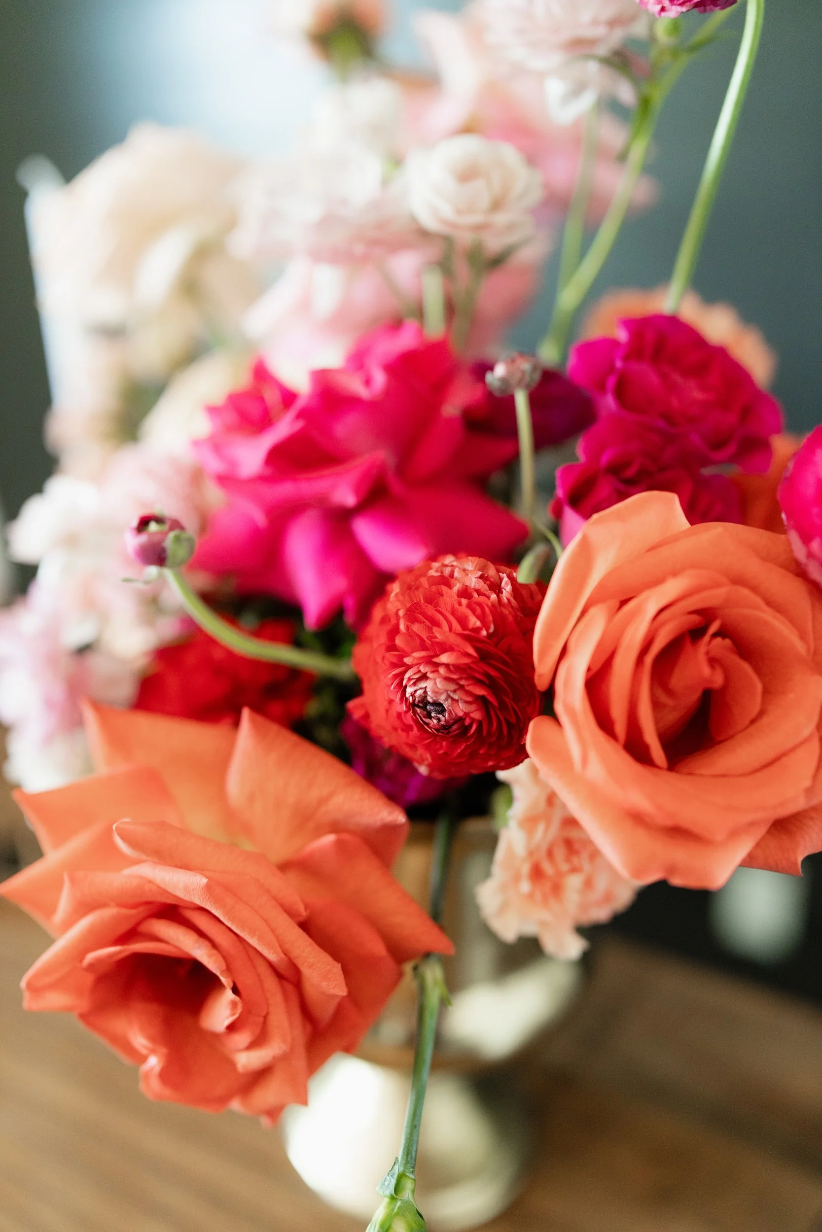 Close view of hot pink, orange and red blooms in an arrangement