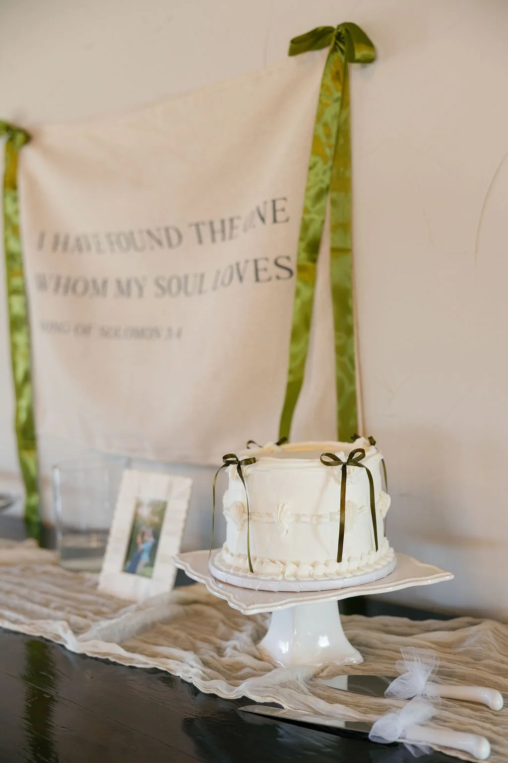 A single classic wedding cake, on a table with cream runners