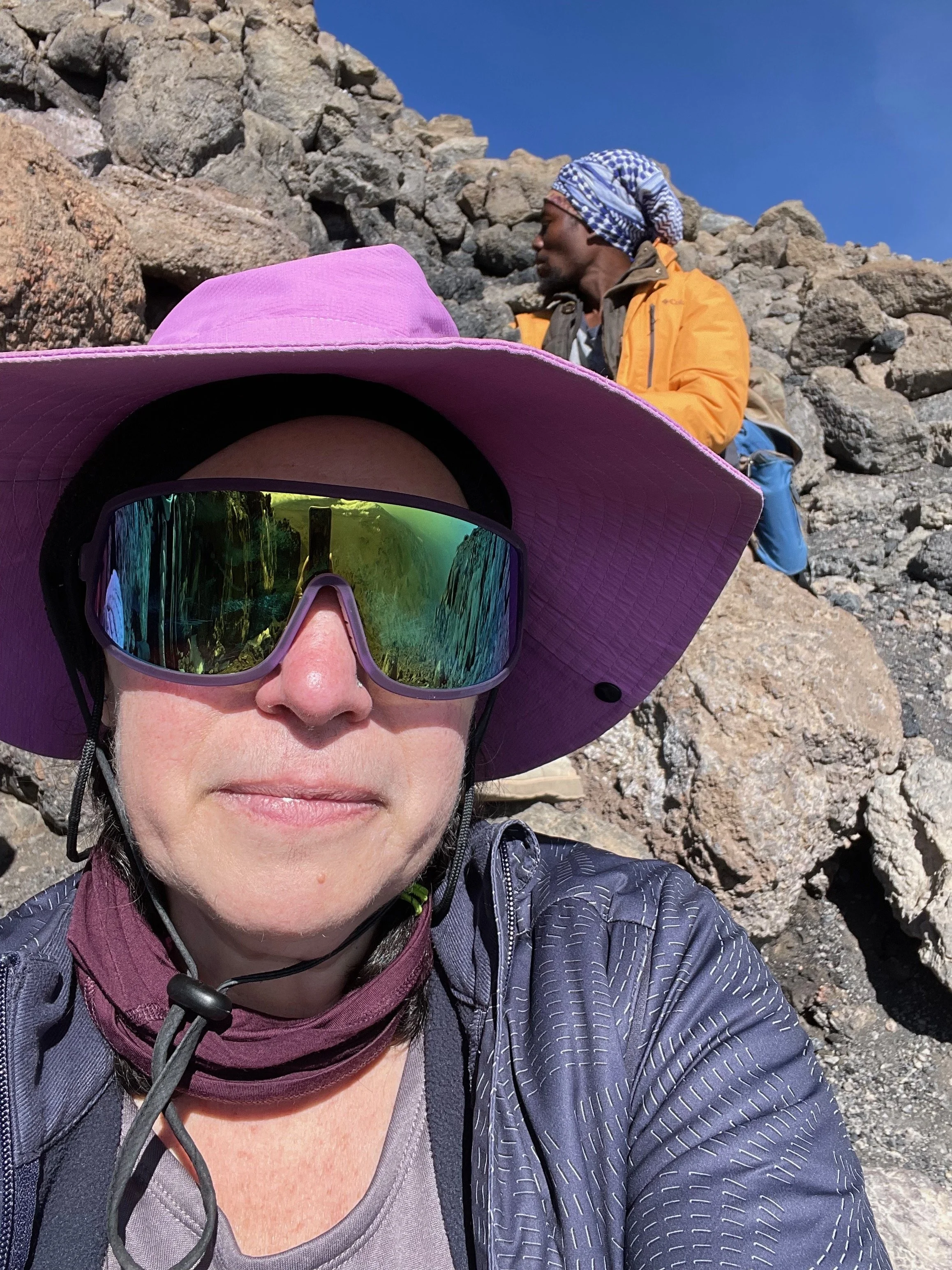 I took this selfie during one of my lowest points on the summit assault. The sun had just risen and we still had so far to go, I wasn't sure how I was going to make it. The background captures an accurate depiction of how steep the climb was.