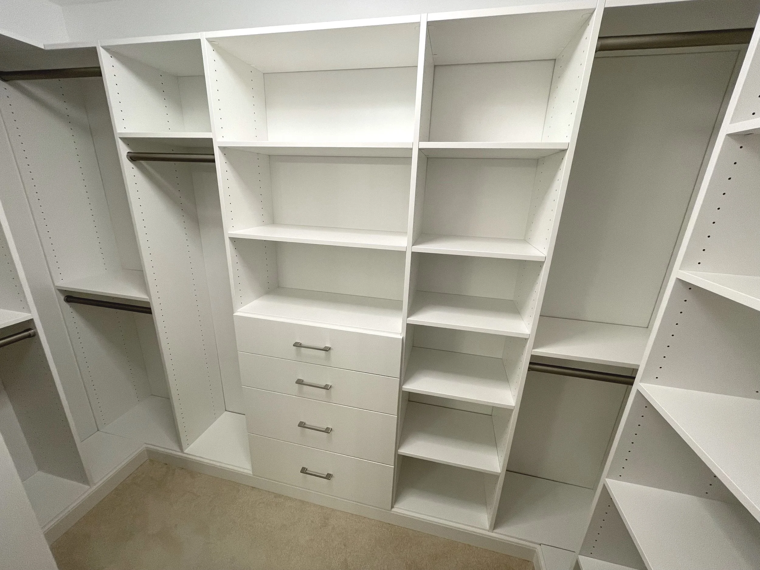 custom walk-in closet wardrobe with built-in drawers, hanging rods, and shelves