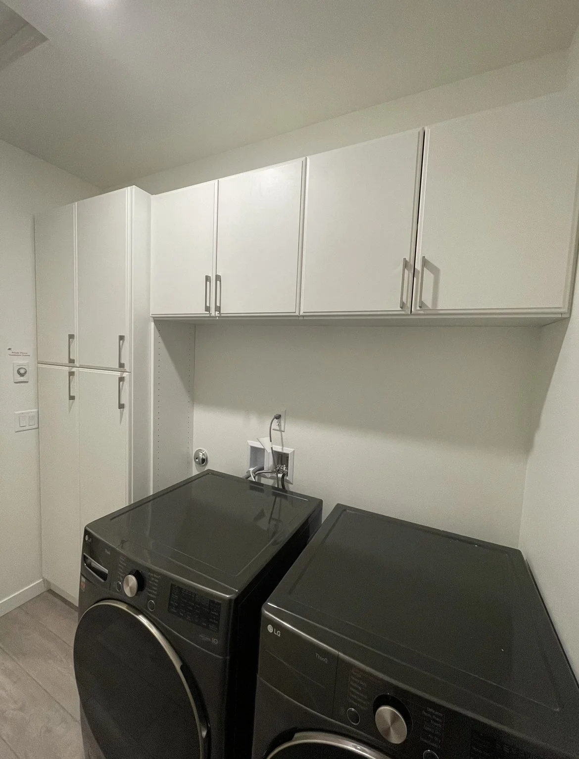 custom laundry room cabinets hanging and standing