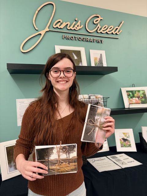 Student showing photographic cards