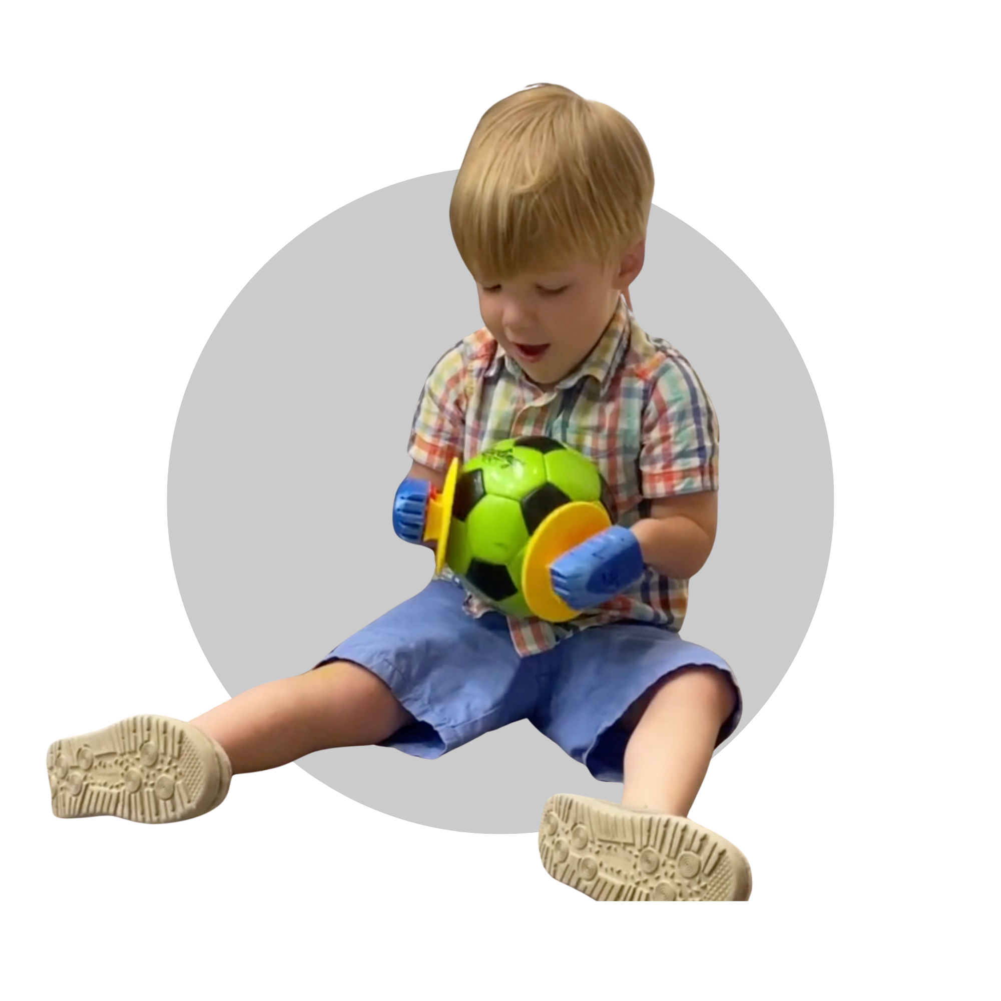 Boy using assisted technology to hold a ball