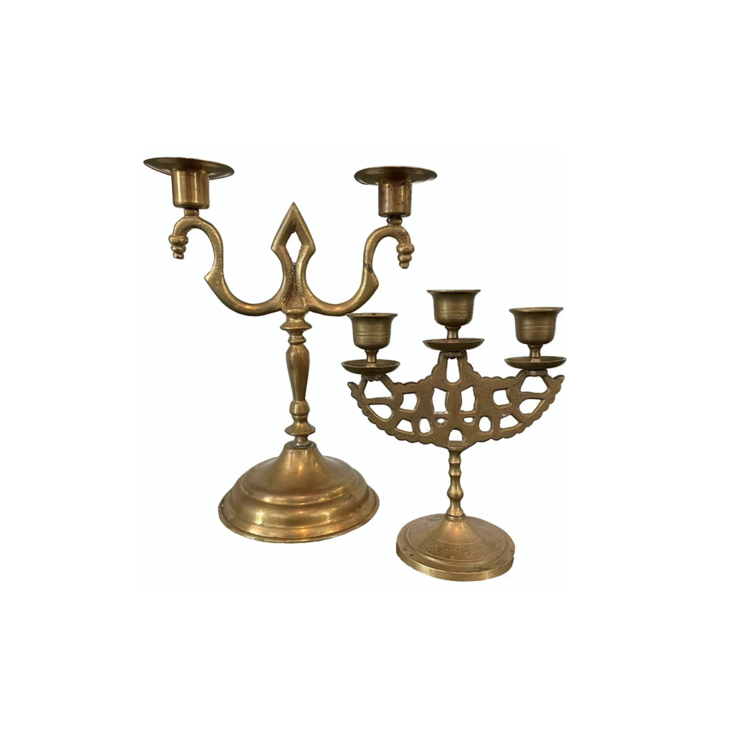 Two brass menorahs, one larger with three branches and one smaller with four branches, isolated on white background.