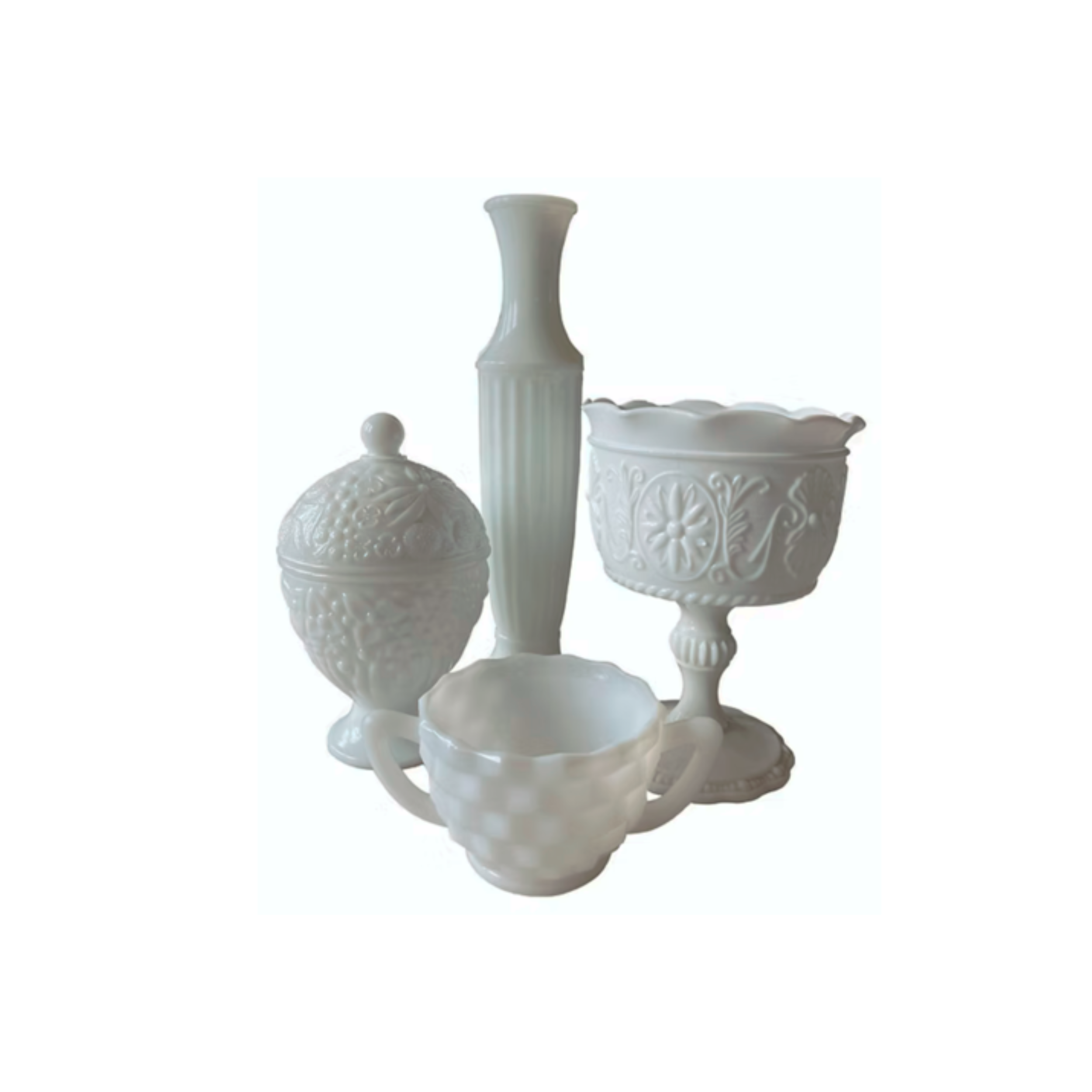 Set of five white ceramic decorative objects, including a vase, a lidded jar, a bowl on a pedestal, a small bowl with handles, and another bowl with a textured surface.