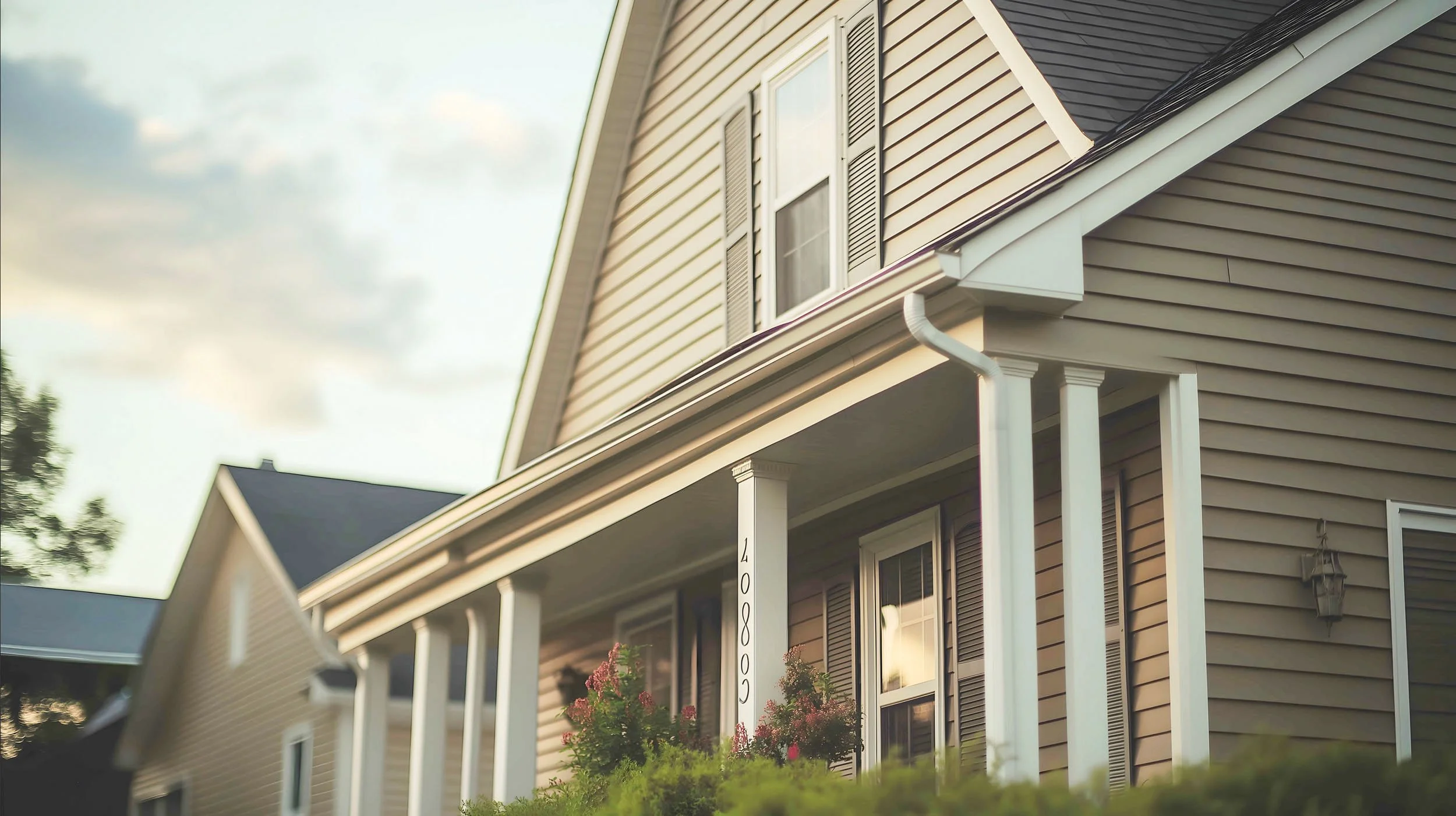 20250722-4seasonshome-rockville-sunset-grey-siding-house-shuttered-window-covered-porch-2500.jpg