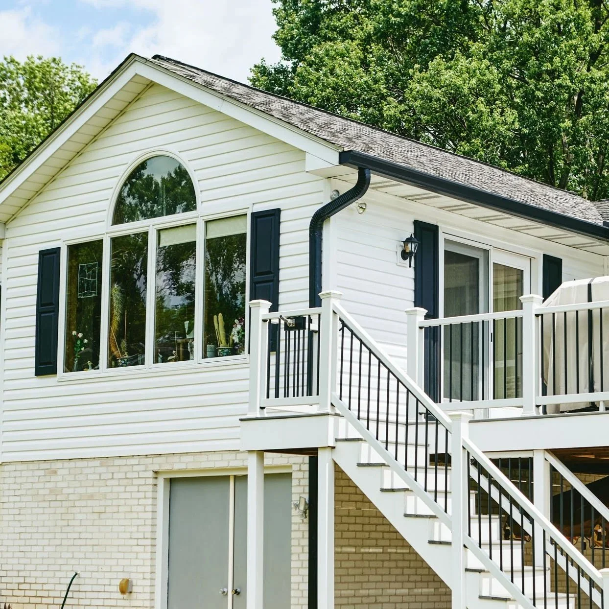 20250731-4seasonshome-rockville-professional-white-siding-black-gutter-deck-installation-angled-2500.jpg