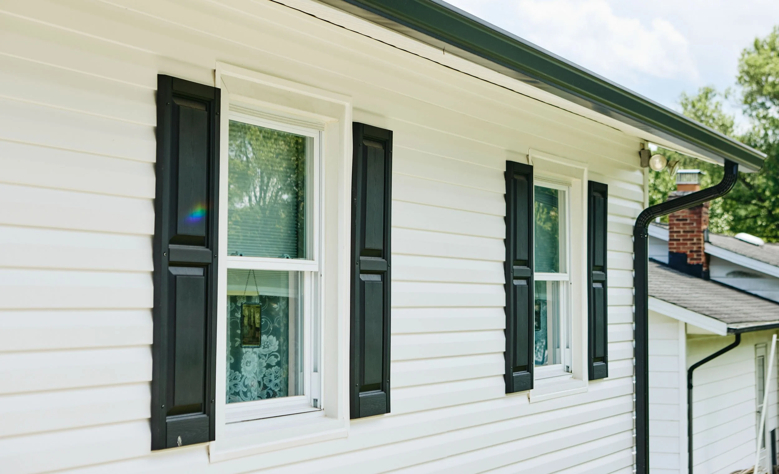 20250731-4seasonshome-rockville-professional-white-siding-black-gutter-black-shutters-2500.jpg