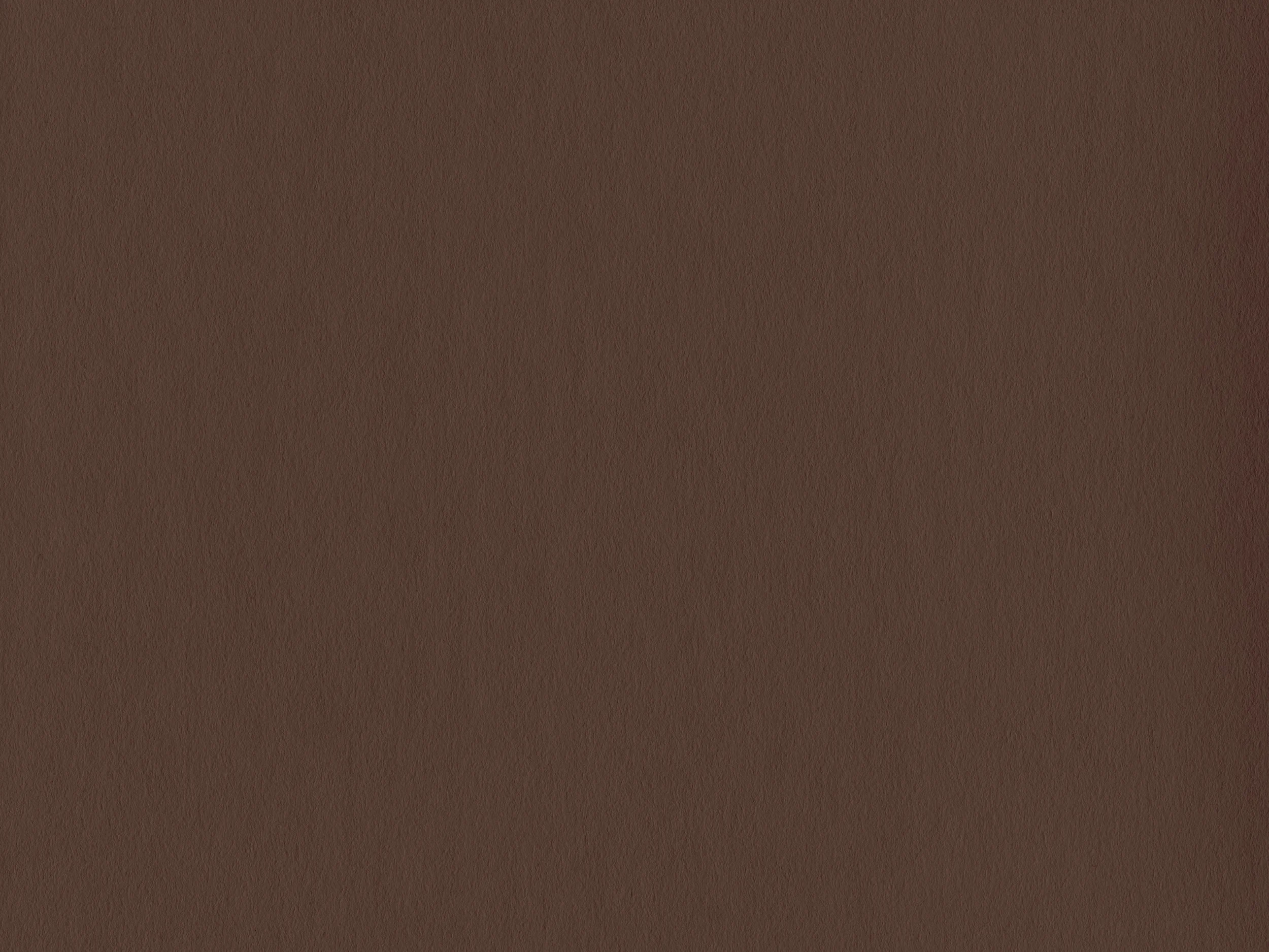 A close-up of a brown textured surface, possibly a fabric or material.