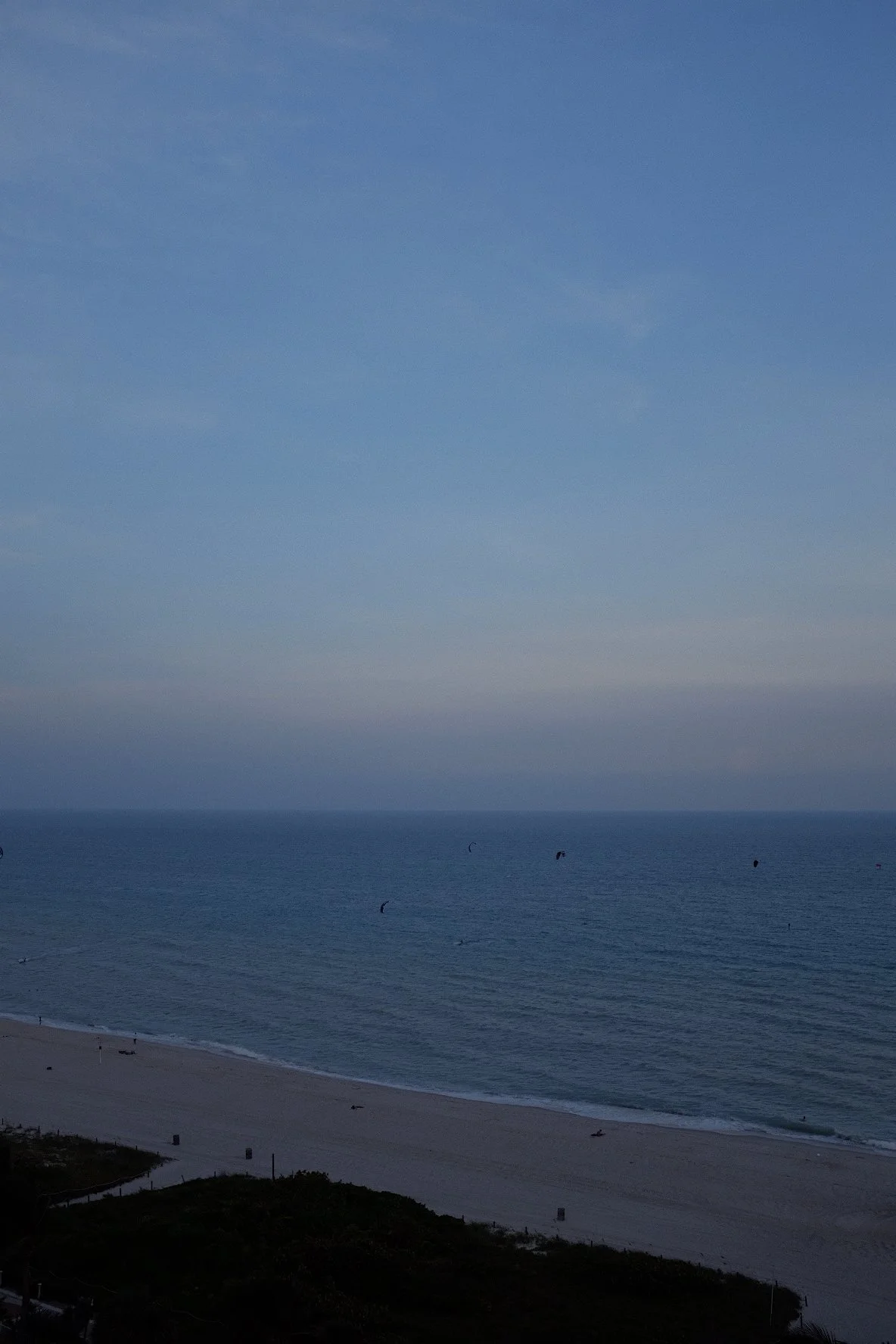 Beach and ocean at dusk with a clear sky