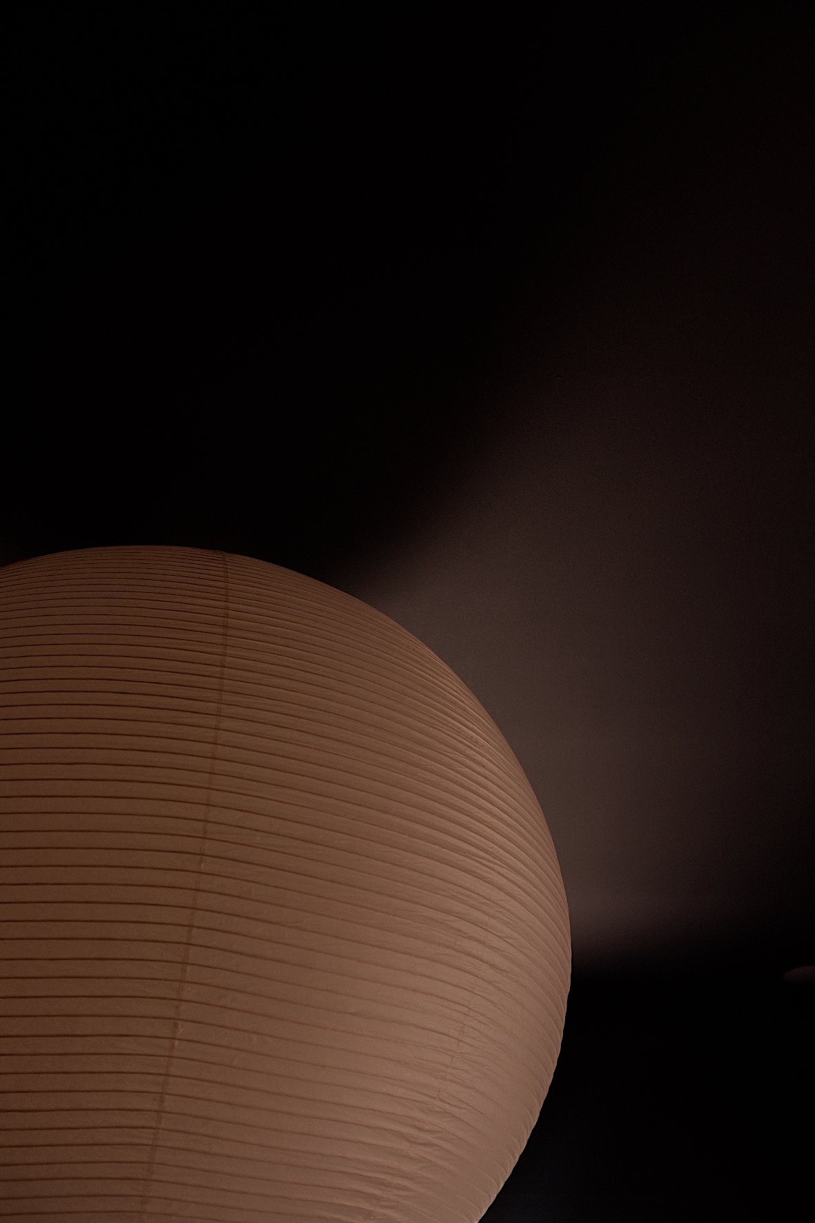 Close-up of a paper lantern against a dark background.