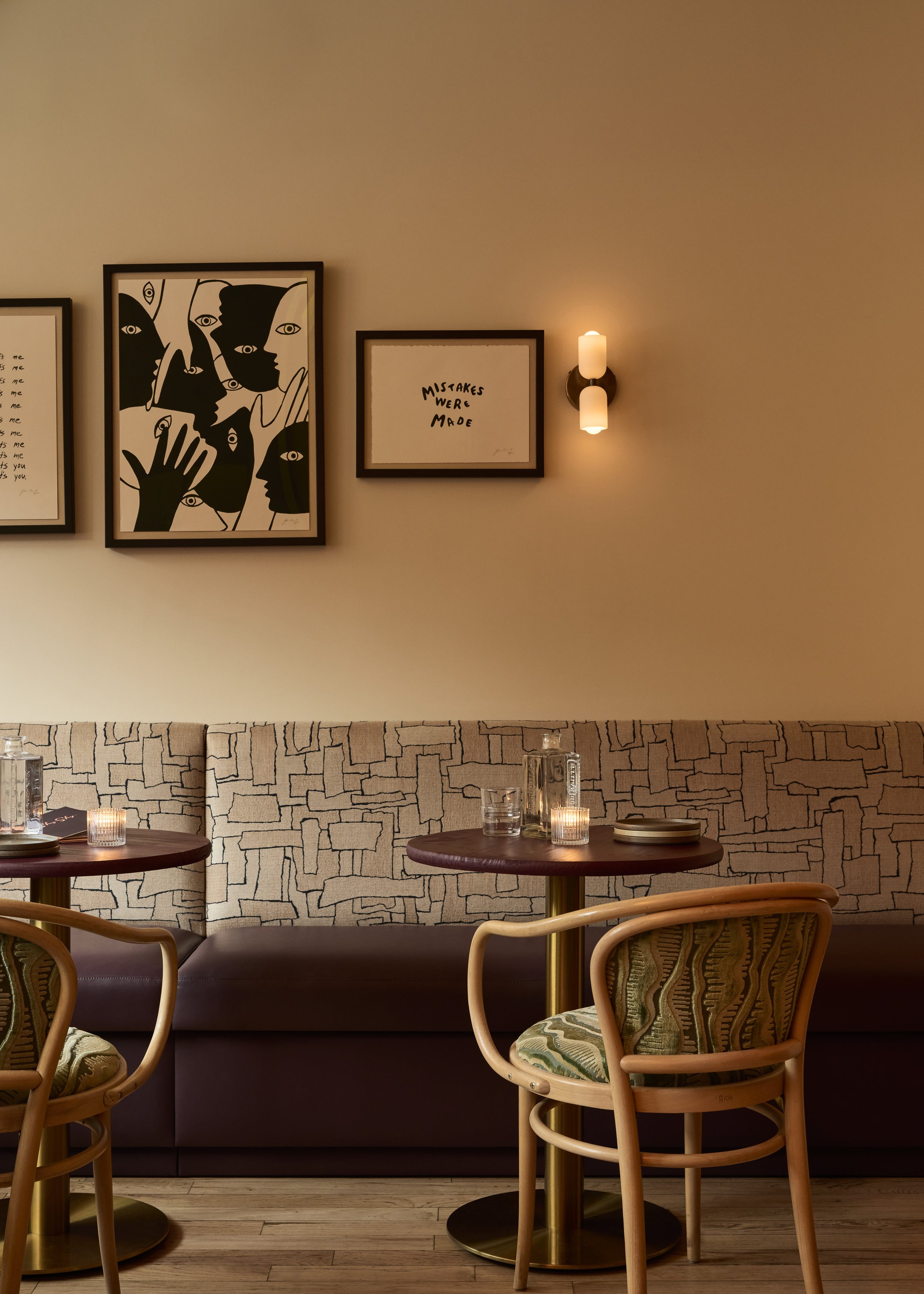 Sophisticated interior design at Shy Shy in Chelsea, NYC, featuring modern custom made seating, textured walls, ambient lighting, and curated contemporary artwork piece by Beaudry Collier, the boutique design firm behind the bars interior.