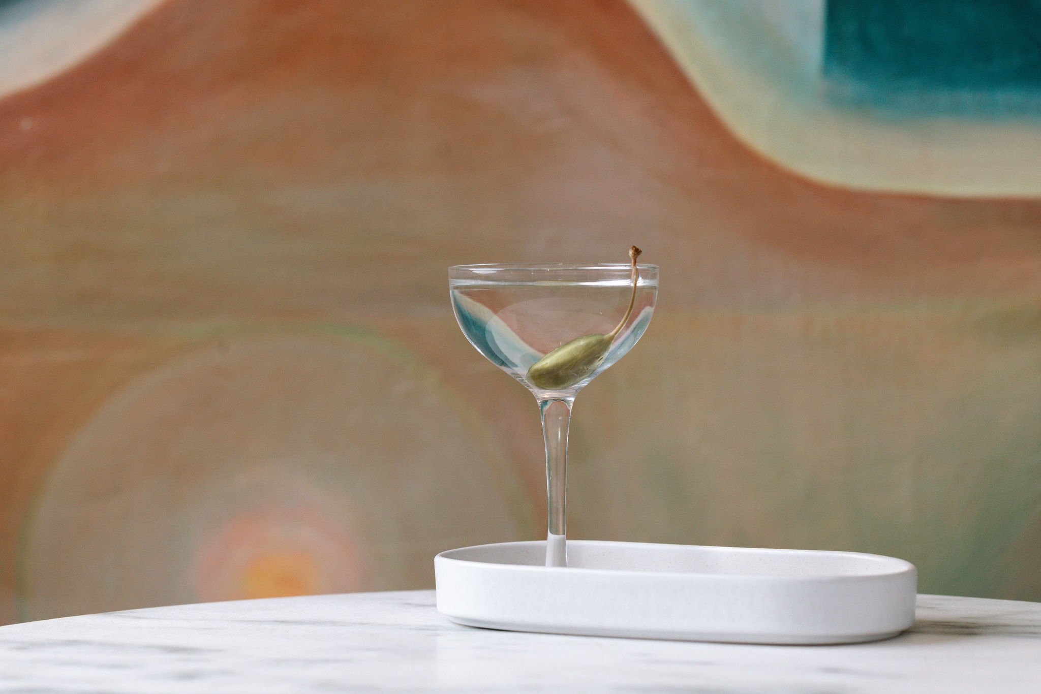 Shy Shy's signature Caesar salad-inspired martini, a bold and savory twist on the classic dish, featuring Ketel One Vodka, EVOO, Lemon Zest. A must-try at Chelsea's top cocktail bar