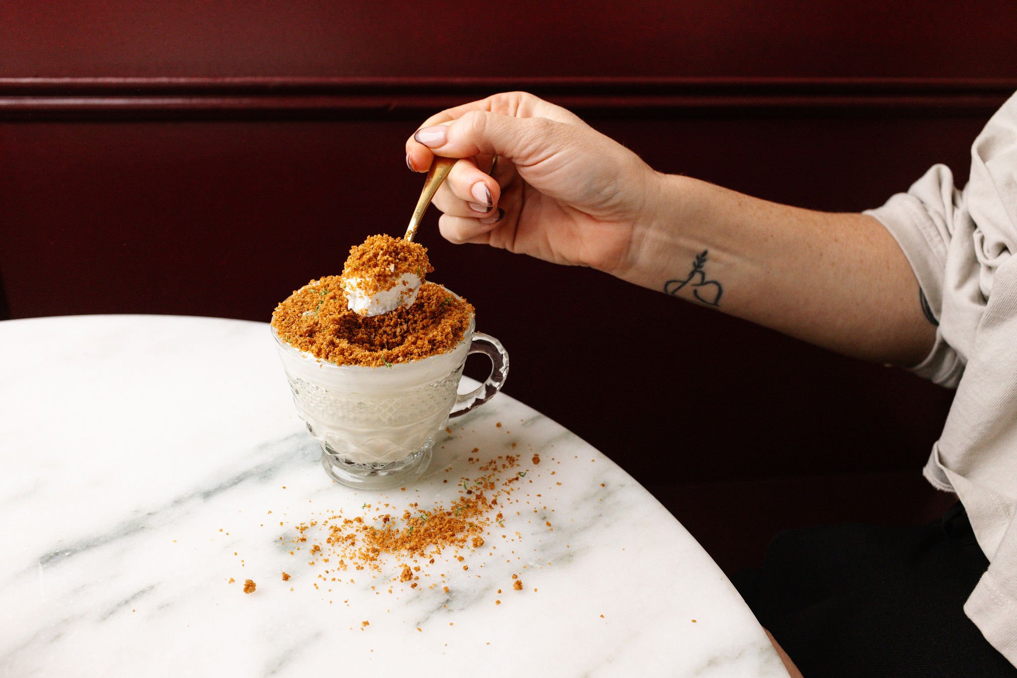 Key lime Pot de Creme at Shy Shy I Chelsea, NYC, a creamy citrus dessert topped with graham cracker crumble and served in an elegant teacup. A perfect sweet treat to end the night.