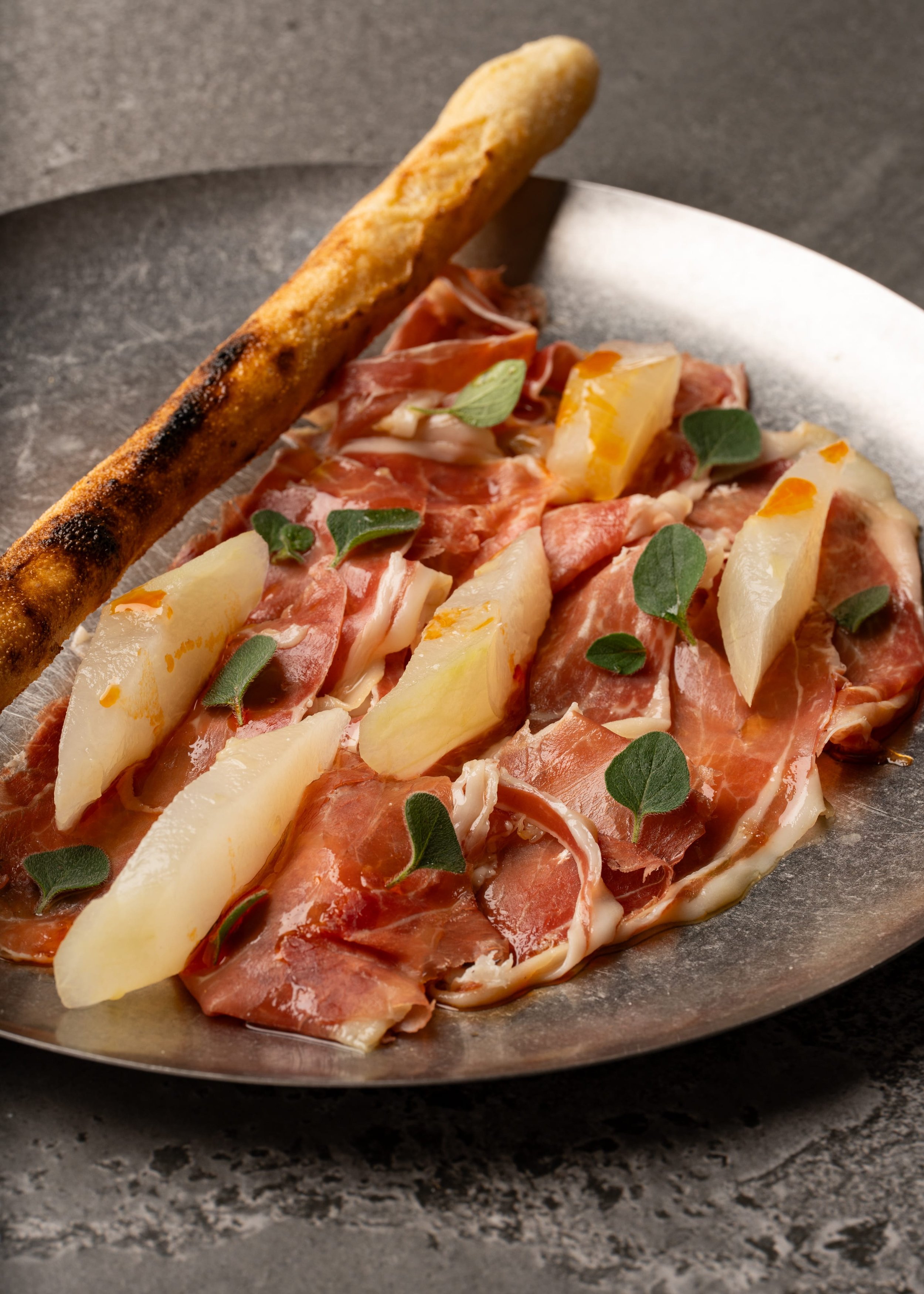 Jamón ibérico, pickled piel de sapo melon &amp; stone-baked bread