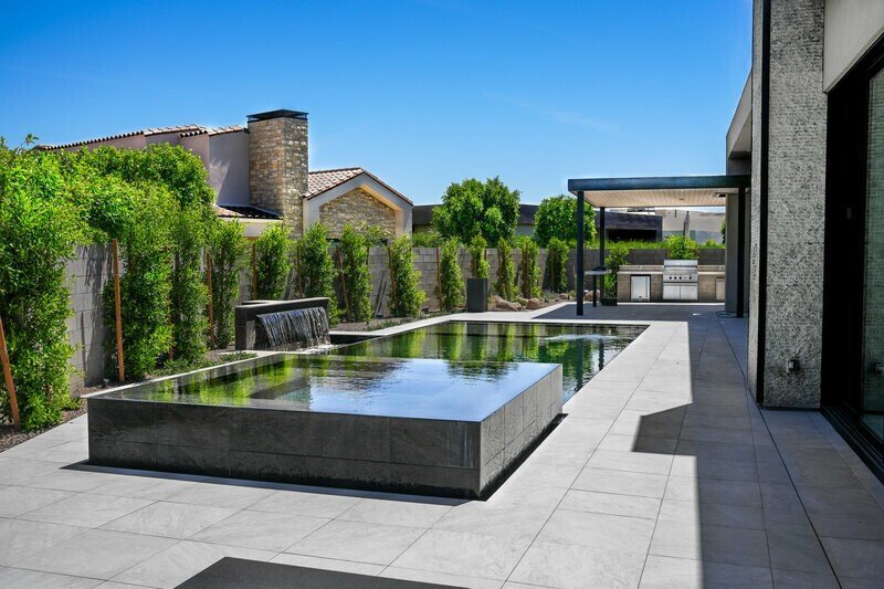Backyard landscape design with pool and water features