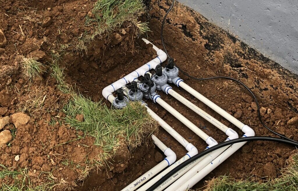 Irrigation system plumbing installed underground at residential property