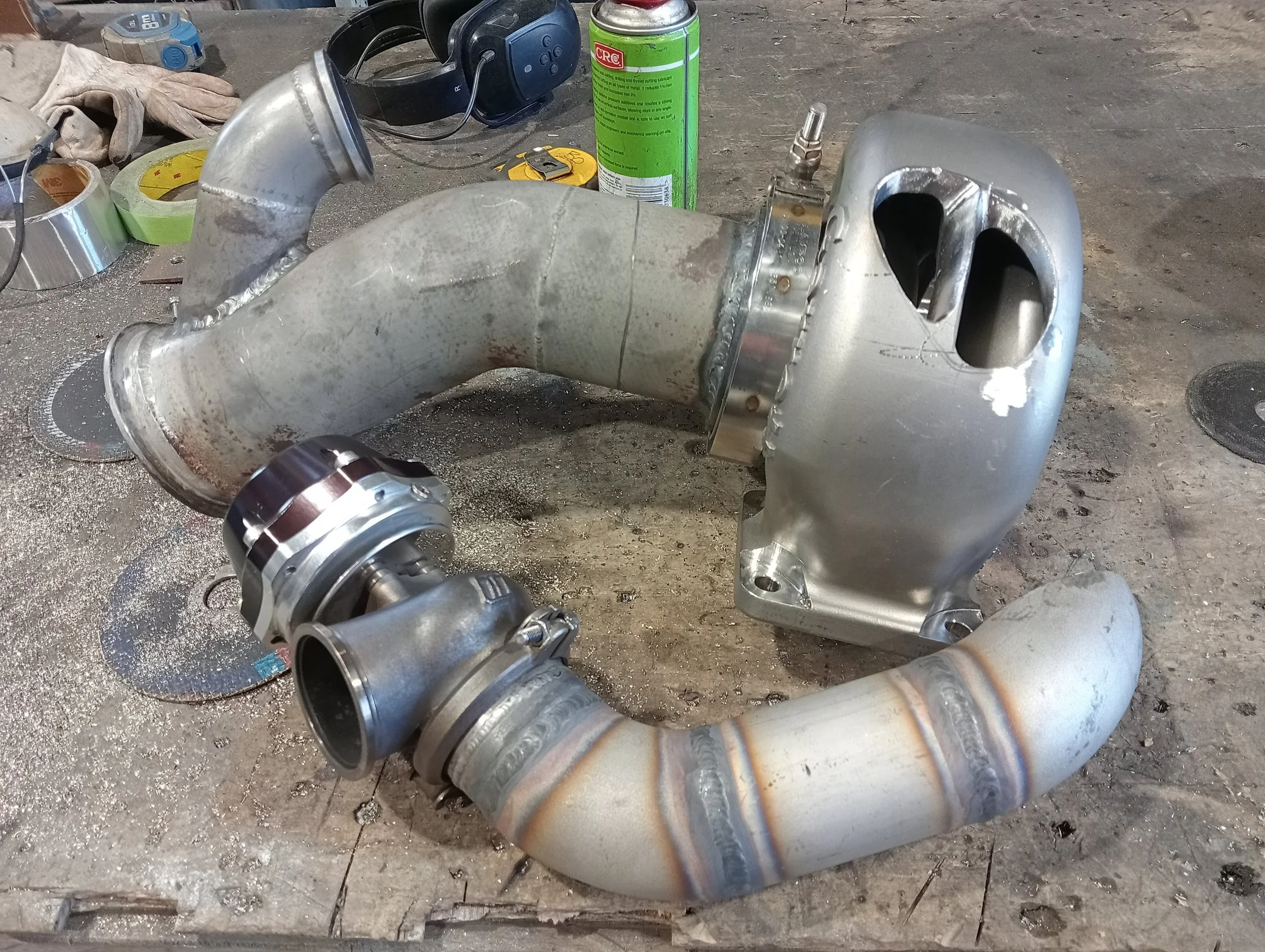 metal automotive turbocharger components on a workbench.