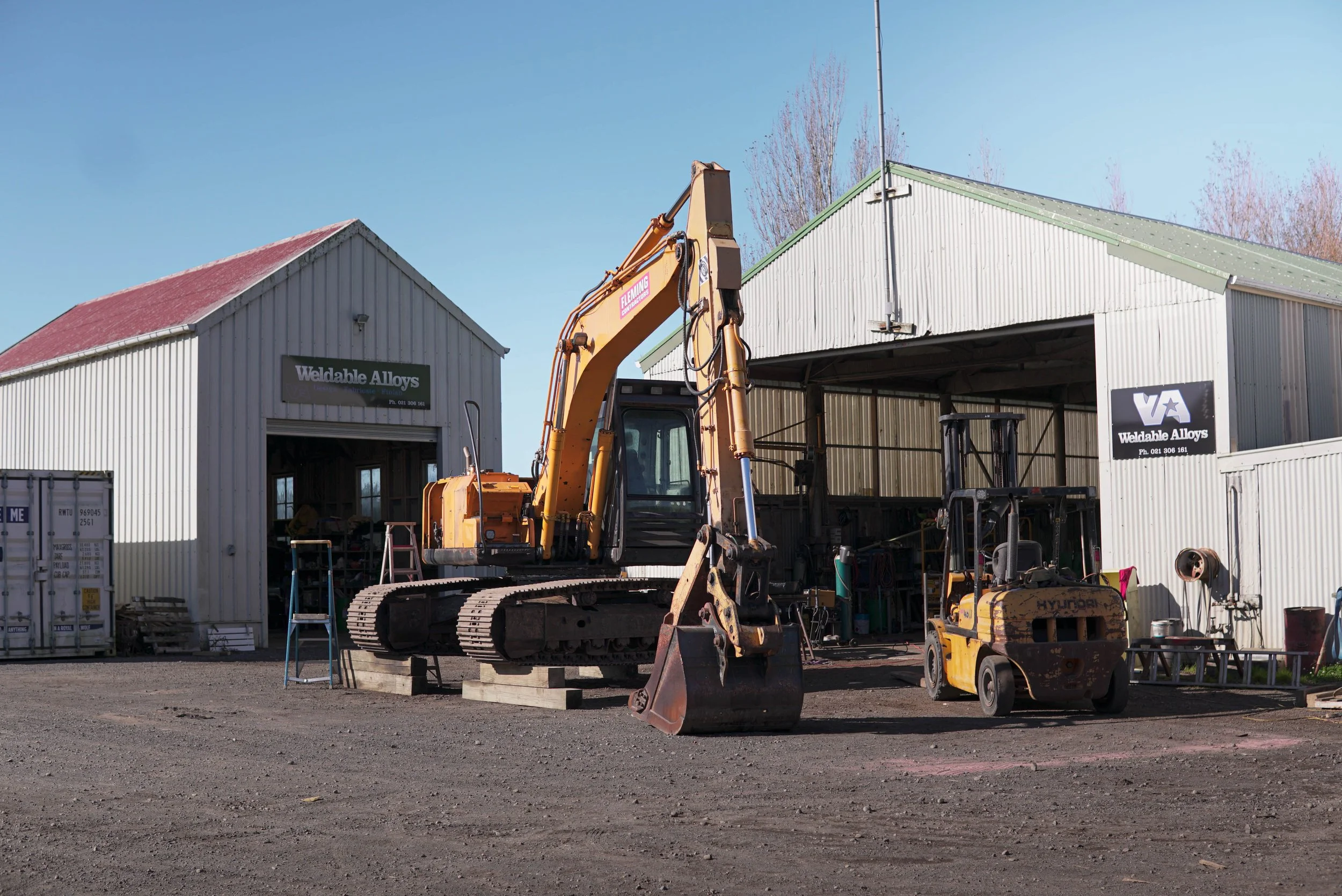 rust repairs on a big excavator located outside weldable alloys workshop