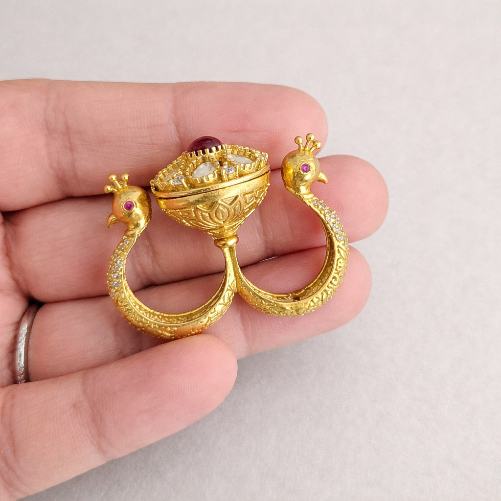 Double Peacock Statement Ring Red Neutral Background Hand.png