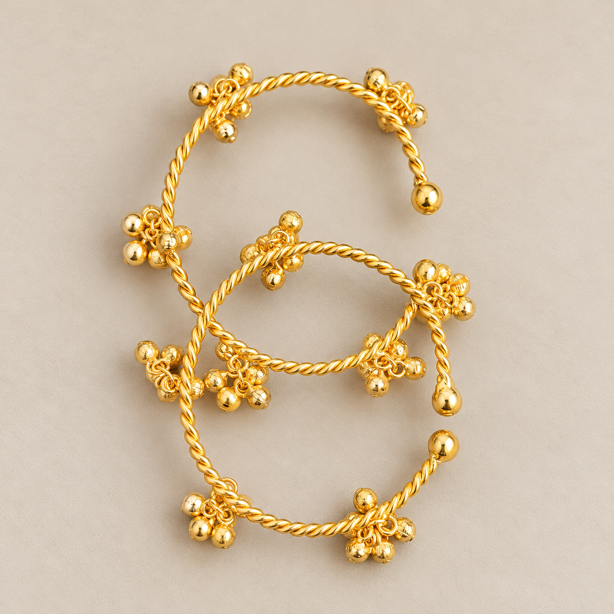 Intertwined Gold Charm Cuff Bracelets.png