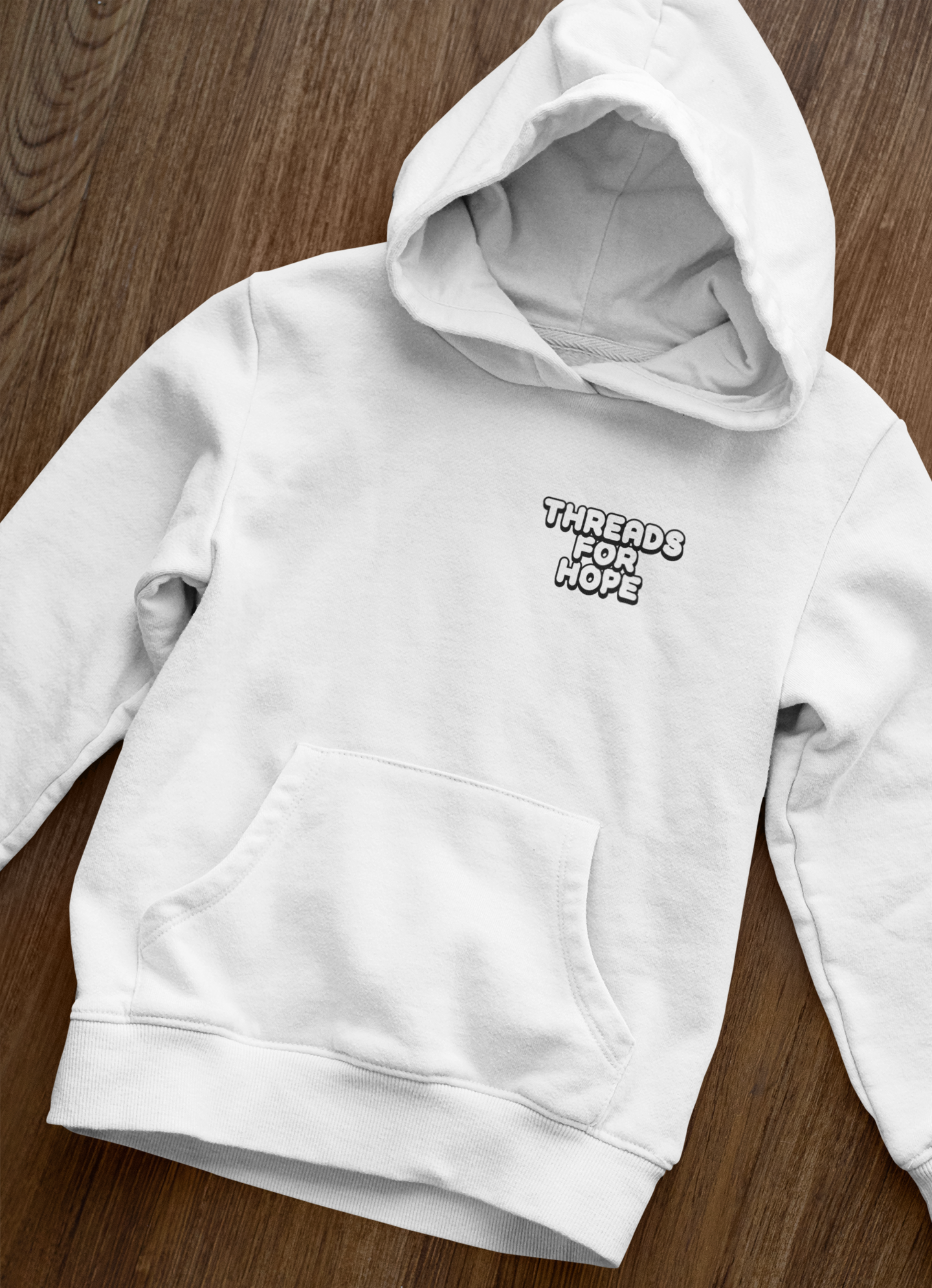 front-view-mockup-of-a-pullover-hoodie-laid-over-a-wooden-surface-33871.png (Copy)
