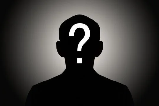 Silhouette of a person with a question mark on their face against a dark background.