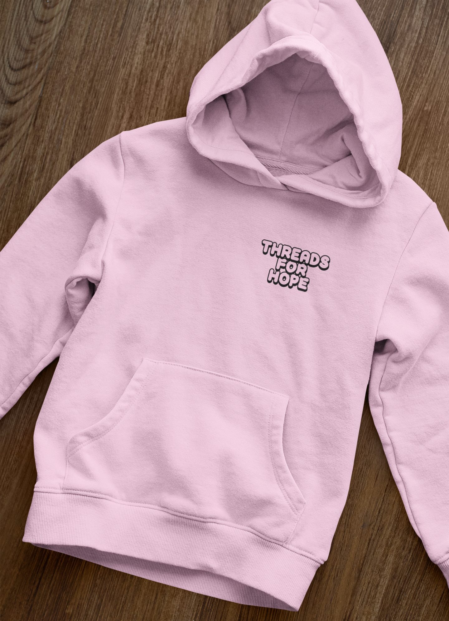 front-view-mockup-of-a-pullover-hoodie-laid-over-a-wooden-surface-33871 (2).png