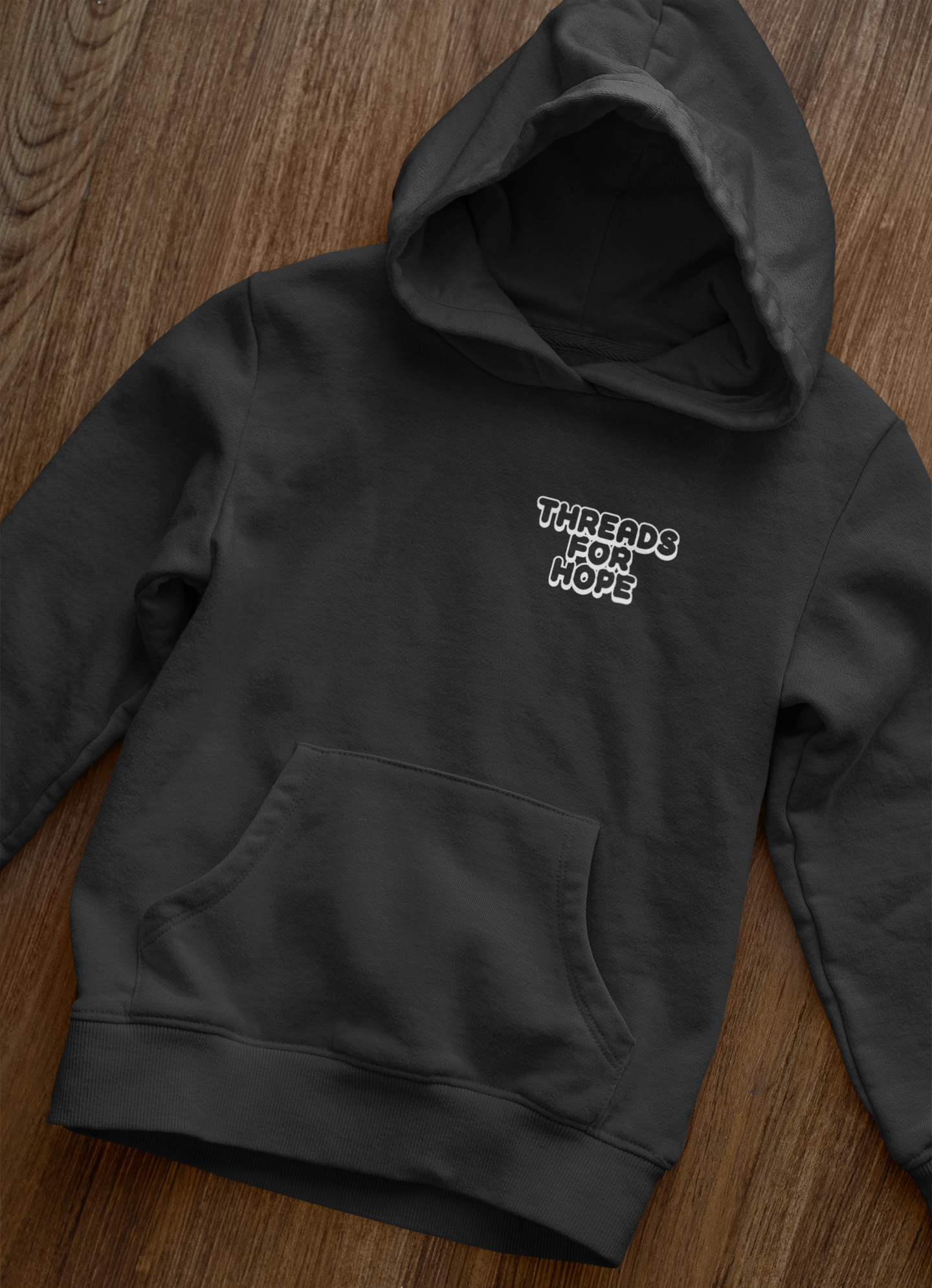 front-view-mockup-of-a-pullover-hoodie-laid-over-a-wooden-surface-33871 (3).png (Copy)