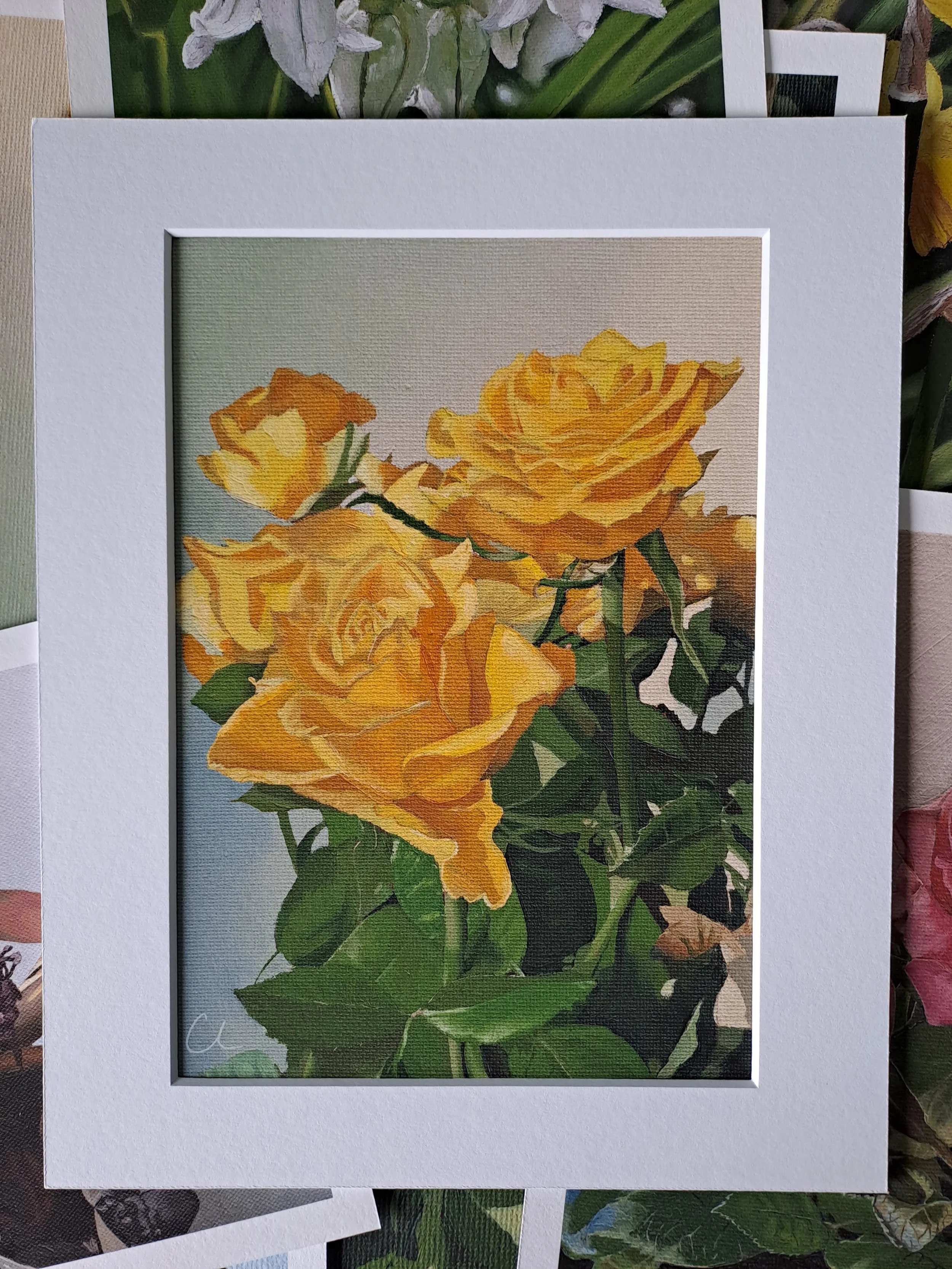 Painted illustration of a bouquet of yellow roses in a white frame.
