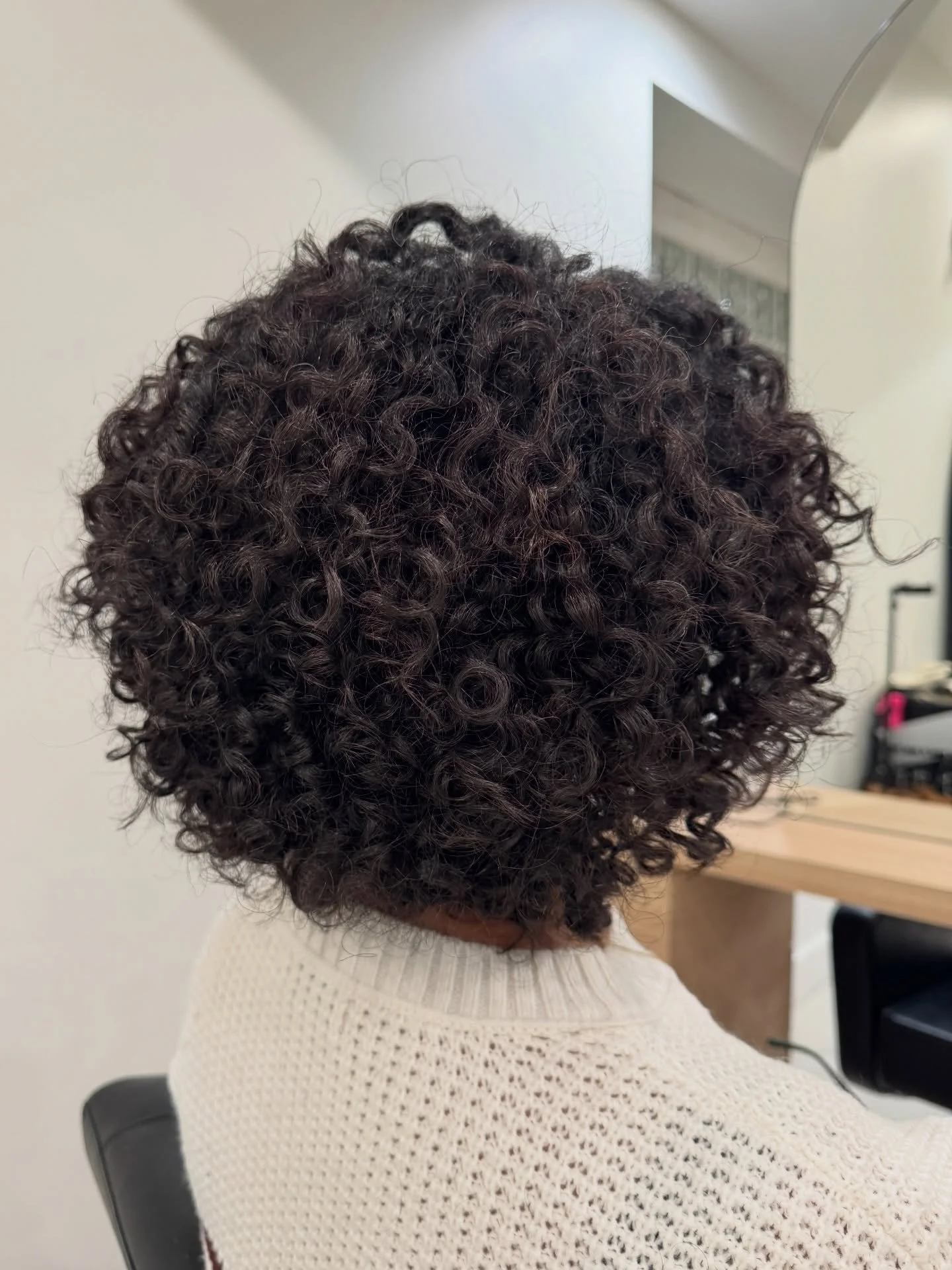 This was a corrective curly cut.

When curls grow out without a strong shape, pieces start going in every direction &mdash; leaving the hair feeling confusing and unbalanced.

Our goal here was simple: balance.
Creating a cohesive layering pattern so