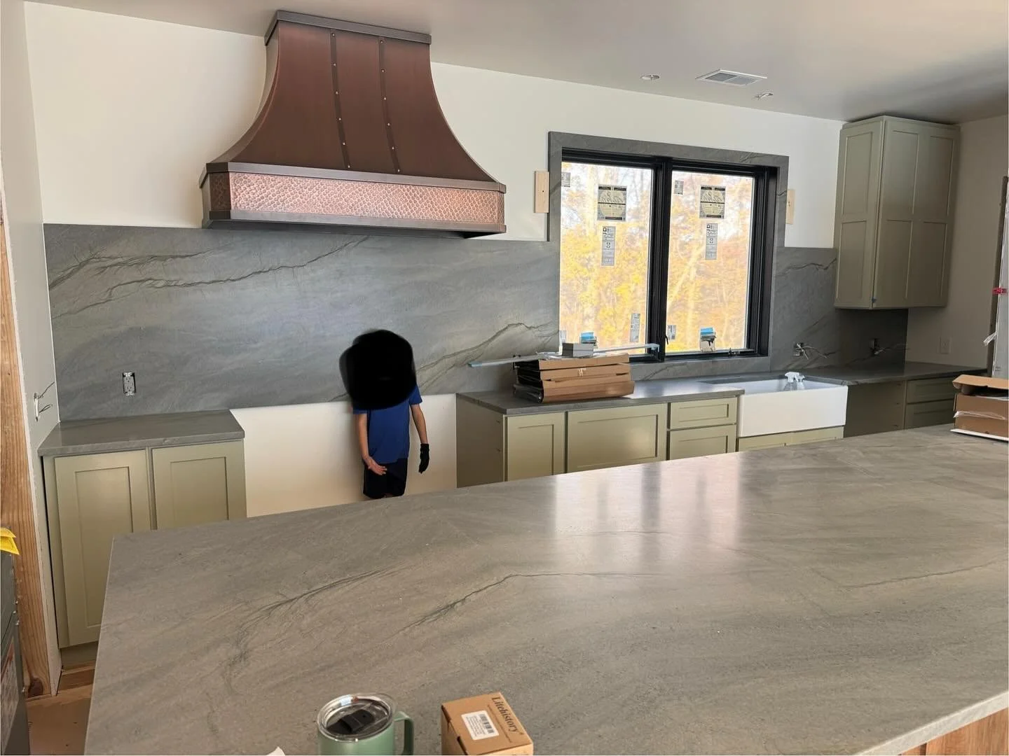 Kitchen almost done! Copper hood in place and countertops installed thanks to @olympiastoneindy (and special little client standing in for the 48&rdquo; range)