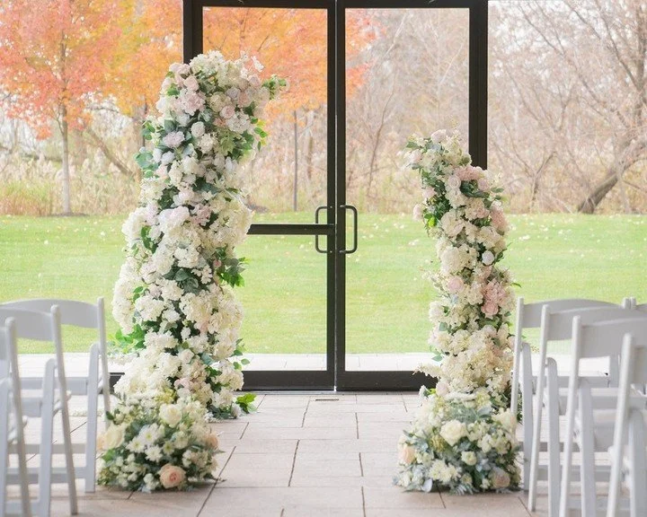 Modern meets organic&mdash;lush floral pillars of ivory, blush, and greenery create a dreamy entrance or altar moment for your vows. Visit our website for wide selection of wedding rentals! 

#TorontoWeddings #LuxuryWeddingsToronto #HighEndWeddings #