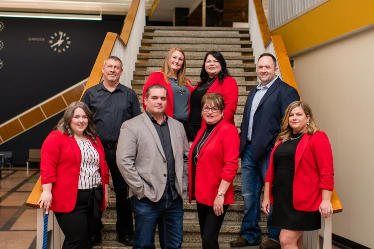 Turner Realty Team on the historic Gander International Airport staircase — Royal LePage real estate agents in Central Newfoundland