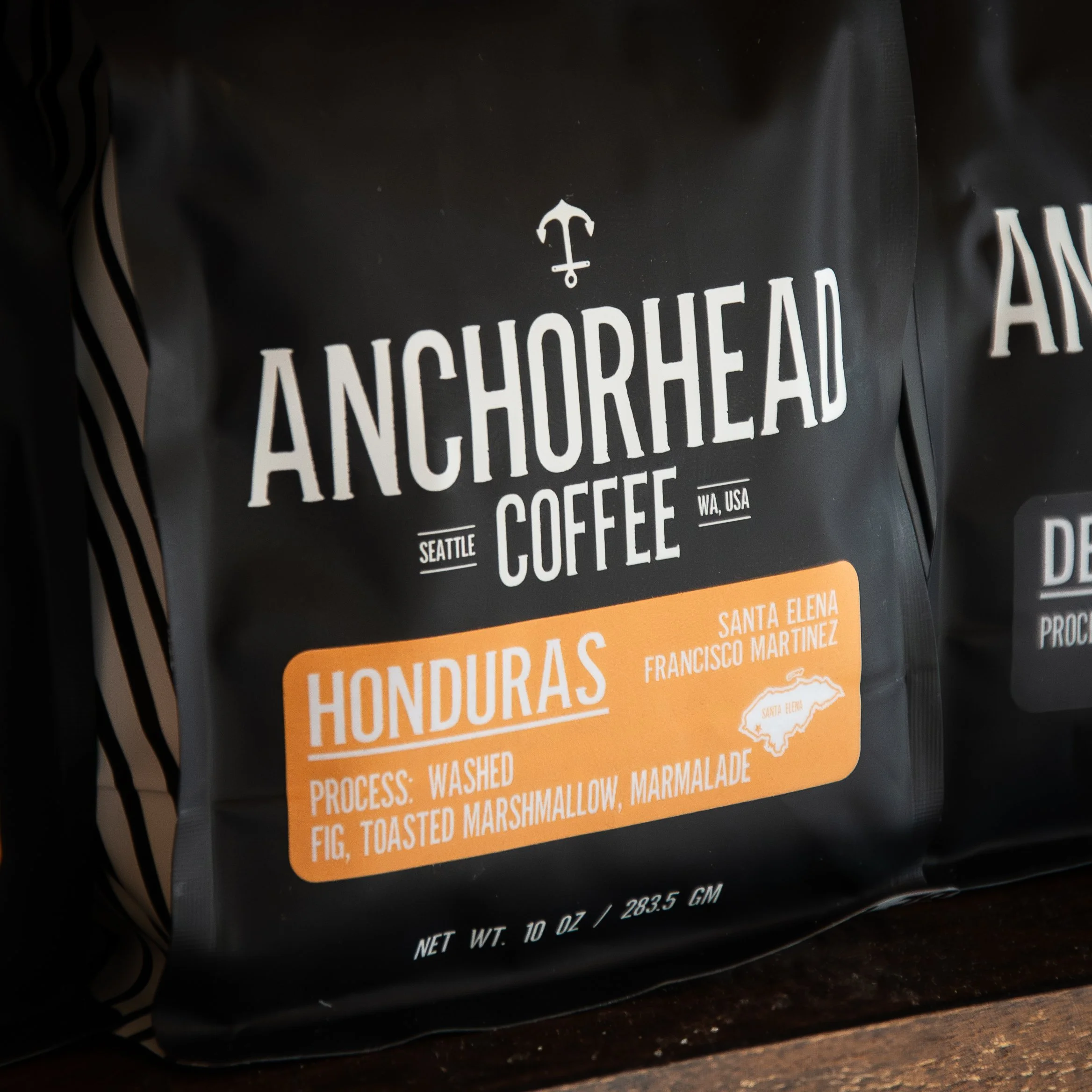 Black coffee bag label with white text and orange details from Anchorhead Coffee, showing Honduras Honduras Santa Elena Francisco Martinez, process: washed, flavor: fig, toasted marshmallow, marmalade, weight: 10 oz.