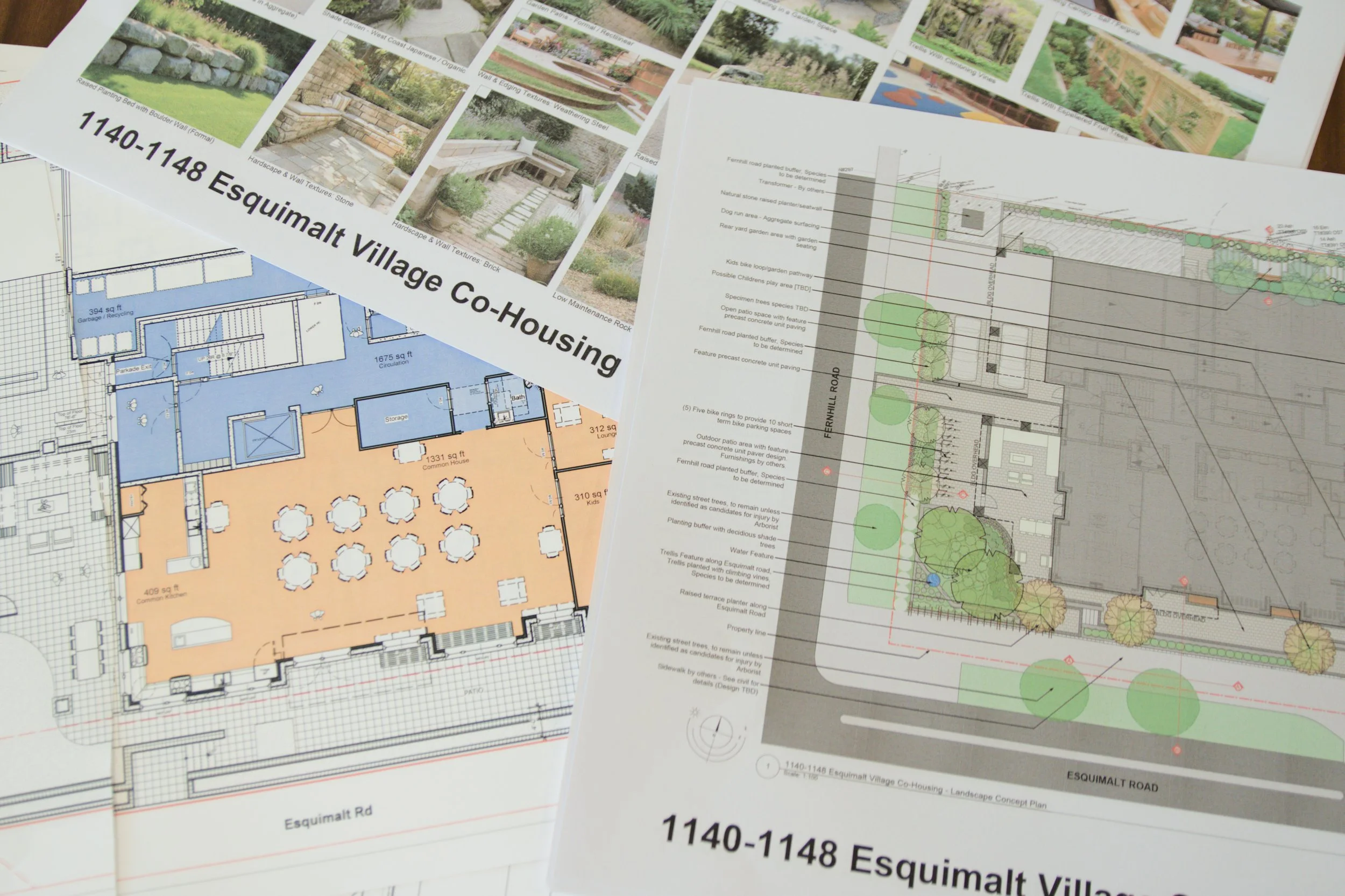 A photo showing designs and renderings of the future home of Esquimalt Village Cohousing