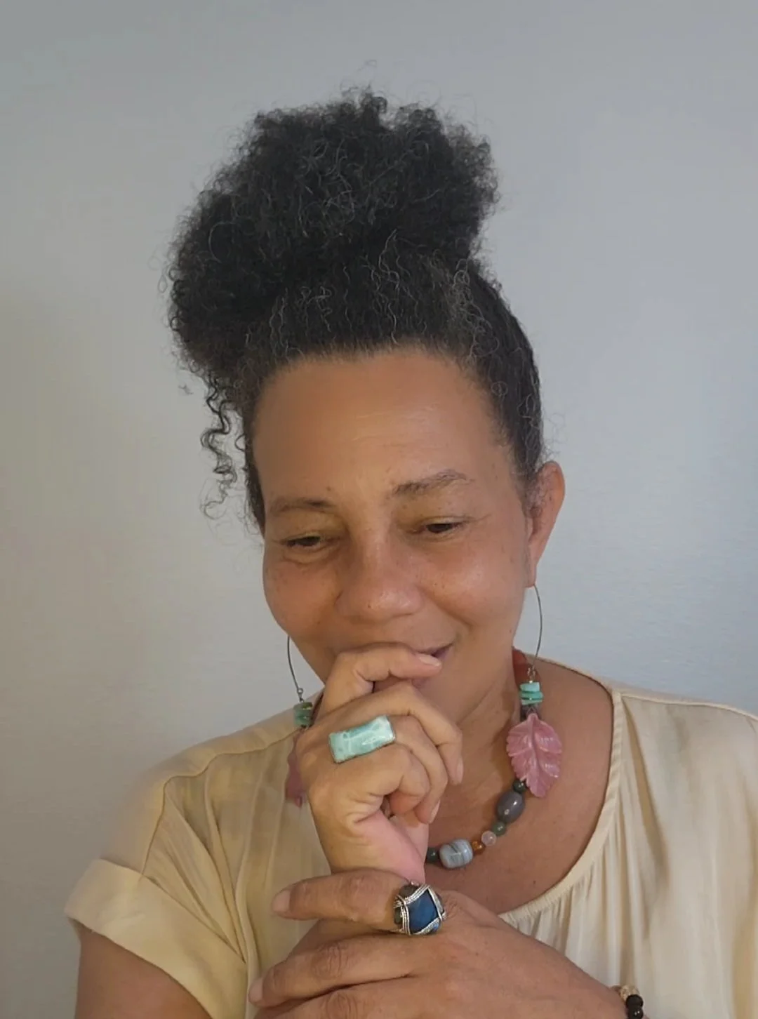 Demetriah Annenayah laughing and looking away from the camera, expressing warmth, authenticity, and embodied leadership.