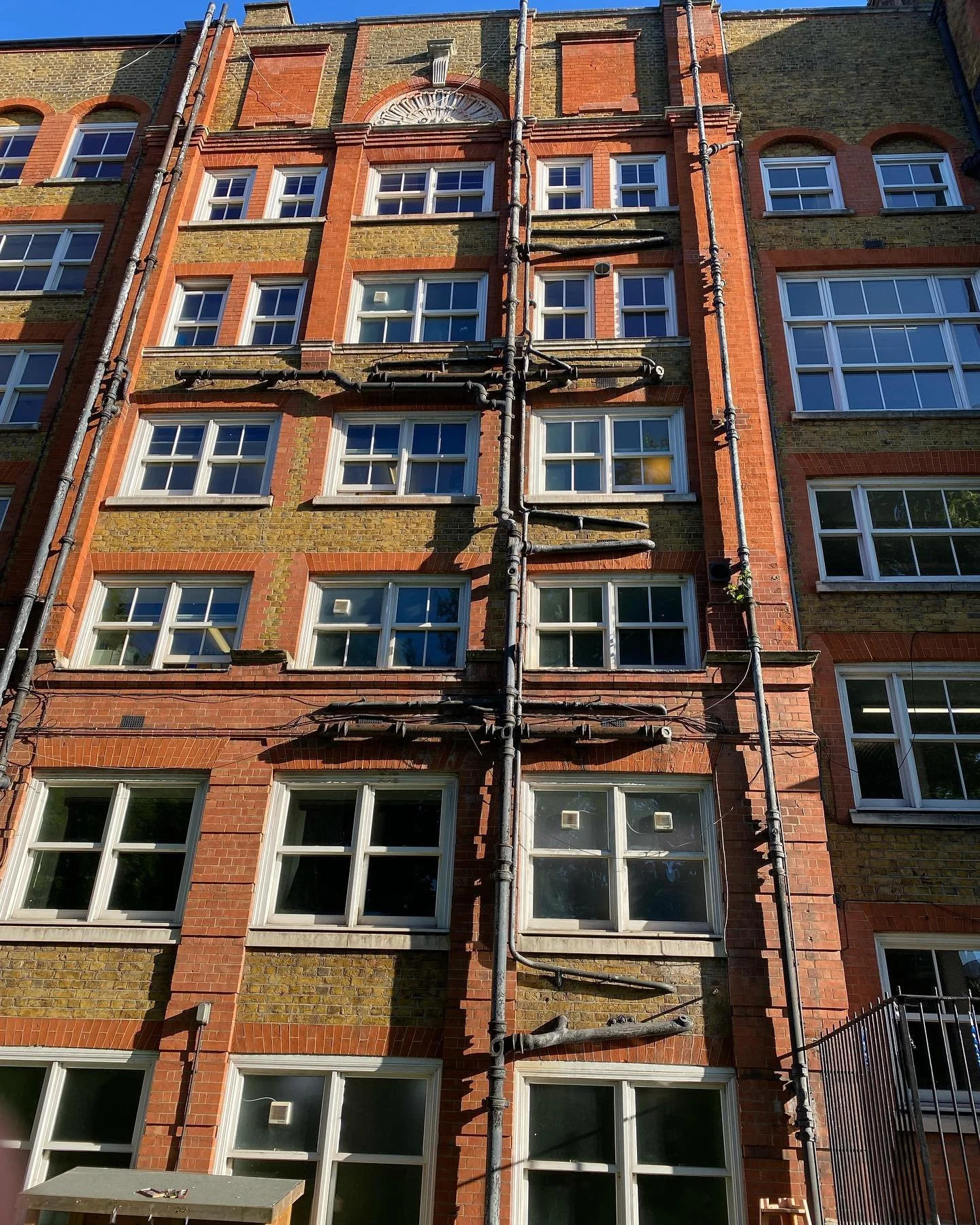 It's always fun to see the plumbing in other cities. Here we see the drainage/waste lines come out of the building through the exterior wall from the bathrooms. This was one way of adding plumbing to older buildings that did not originally have bathr