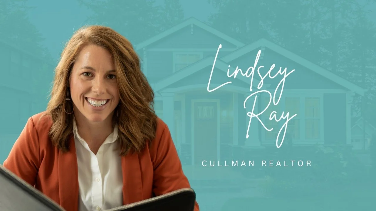A woman with shoulder-length red hair smiling at the camera, sitting in front of a house. The overlay text reads "Lindsey Ray" and "Cullman Realtor".