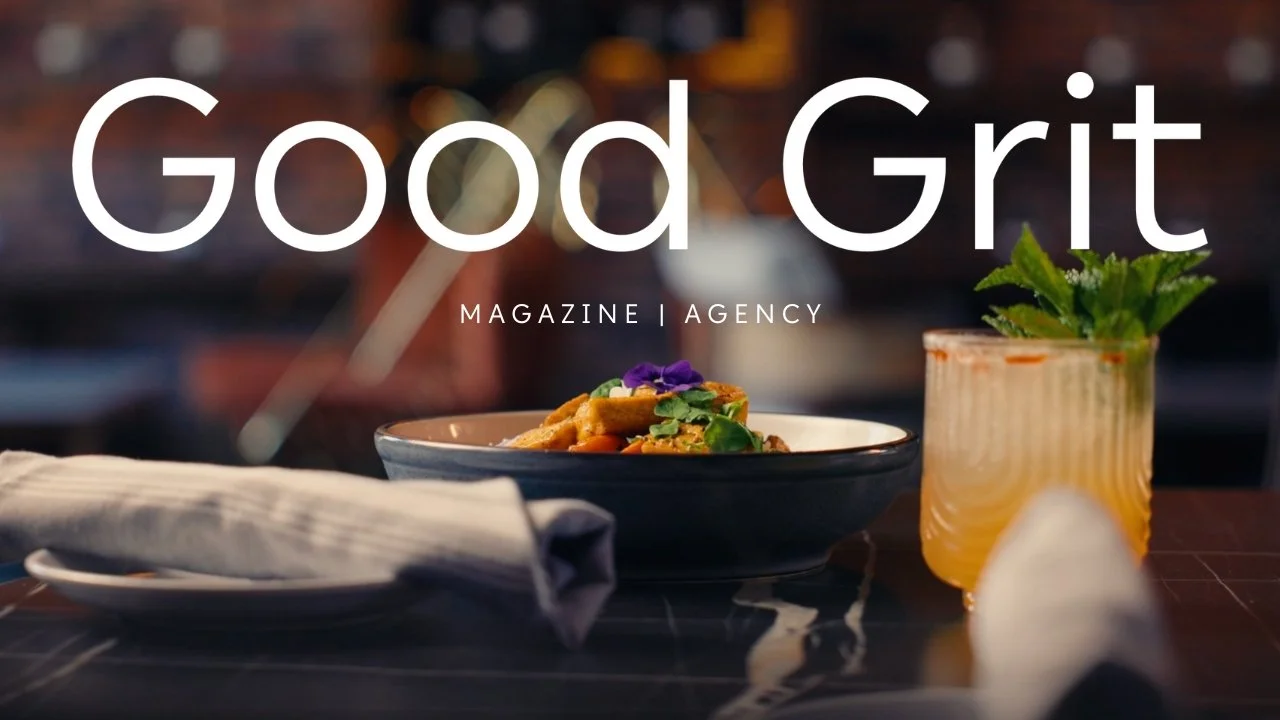 A plate of food and a drink on a dark table, with the words 'Good Grit' and 'Magazine | Agency' overlaid.