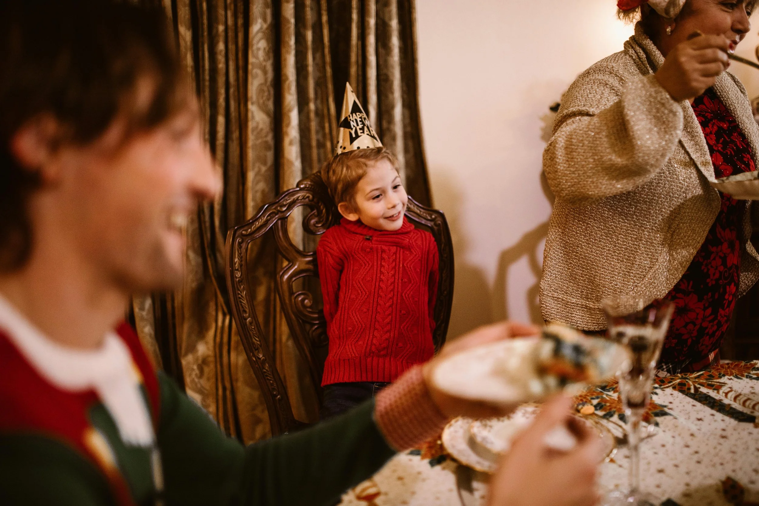 Adults celebrating New Year with sparklers and drinks at festive holiday gathering, illustrating how parents can provide New Year anxious kids support by managing their own expectations during transitions