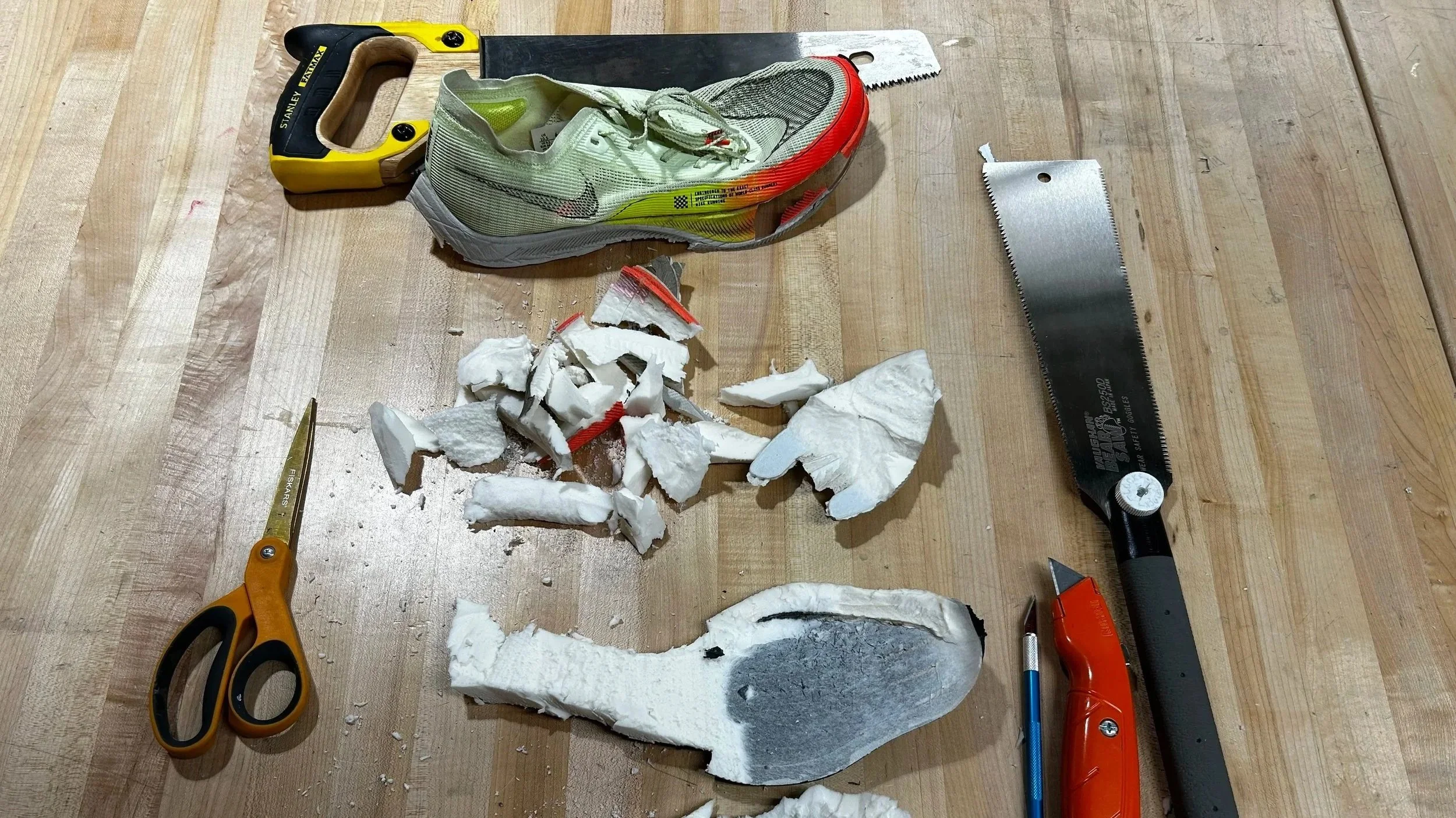 (1) Product teardown - carefully extracting the carbon plate from the foam.