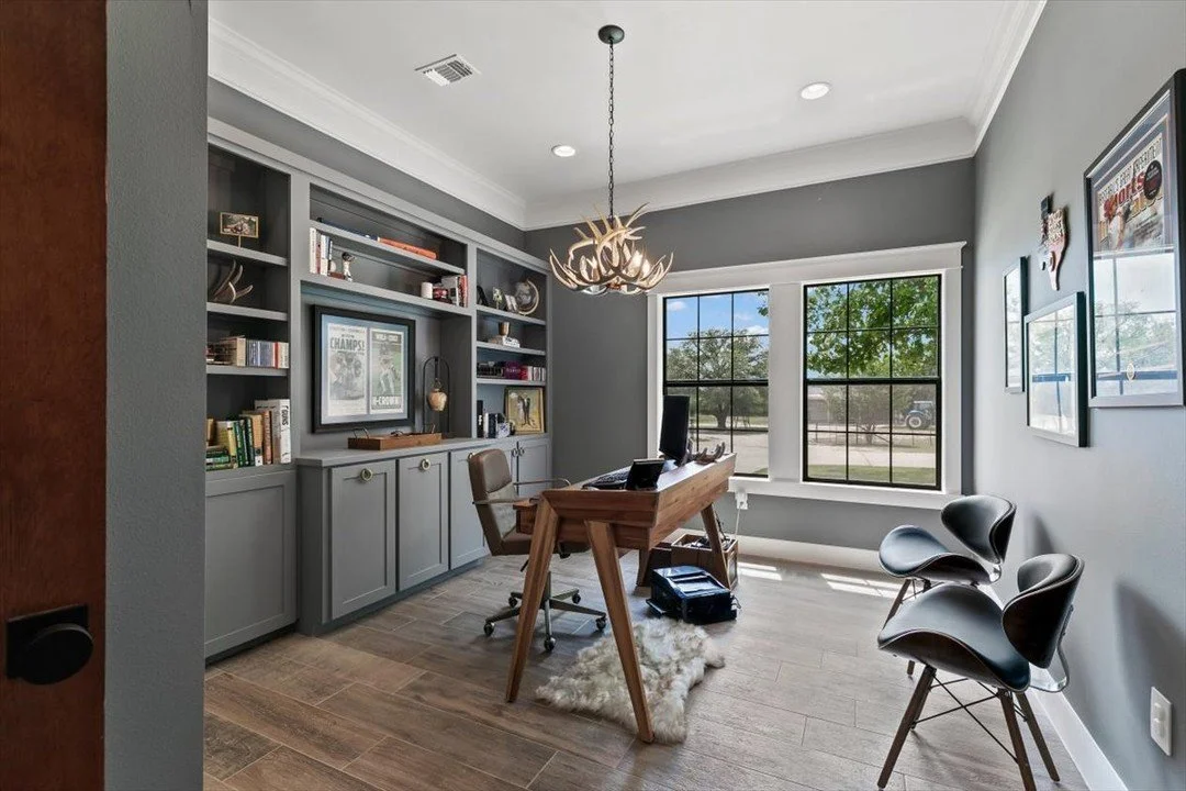 Where rustic charm meets refined sophistication. 

This custom office blends unrefined and elevated design&mdash;featuring a bespoke chandelier crafted from antlers found on the land, paired with aged brass hardware for a timeless touch. It&rsquo;s a