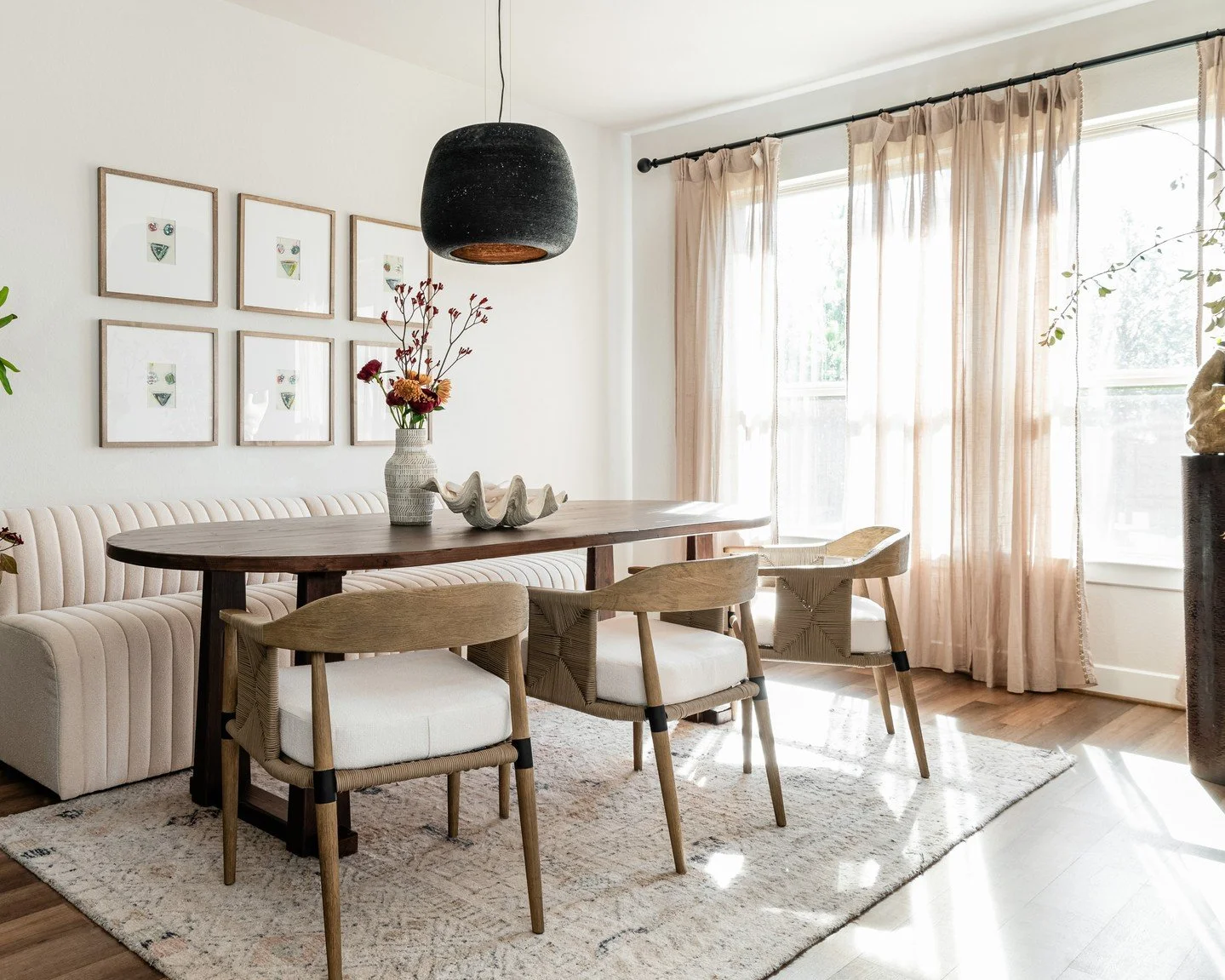 Where warmth meets intention.
Every layer of this dining space was designed to invite connection — from the soft channel-tufted banquette to the natural light filtering through sheer drapery. The blend of textures, tone, and flow makes this ro