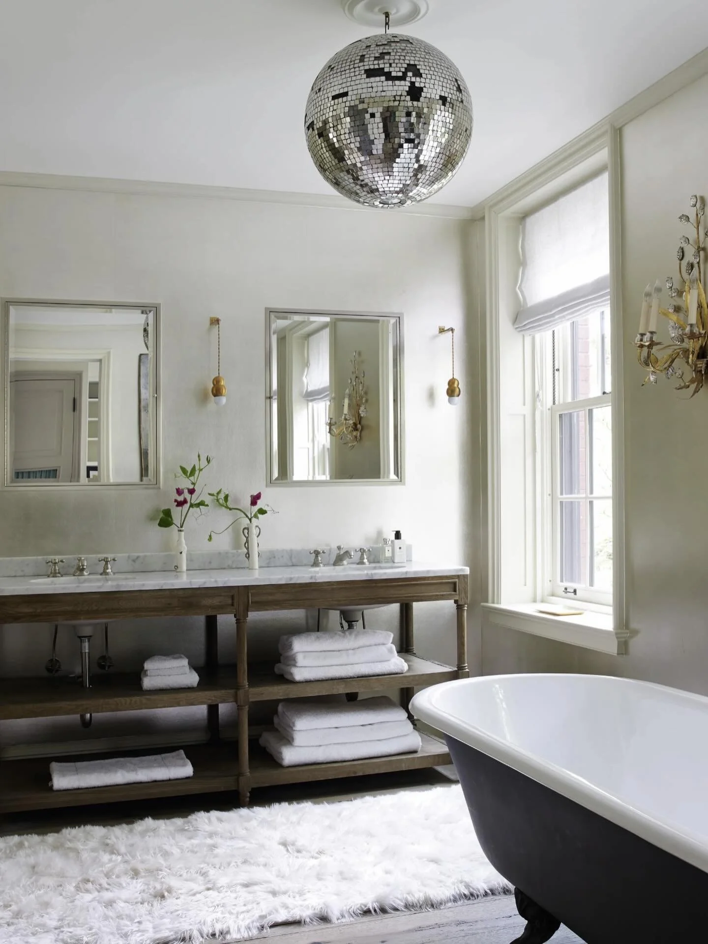 A disco ball and a Victorian bathtub &mdash; proof that contrast can be both refined and stylish. 

Inspired by Poonam Khanna, this space is a reminder that design is meant to stretch us &mdash; to move beyond the expected and into the extraordinary.