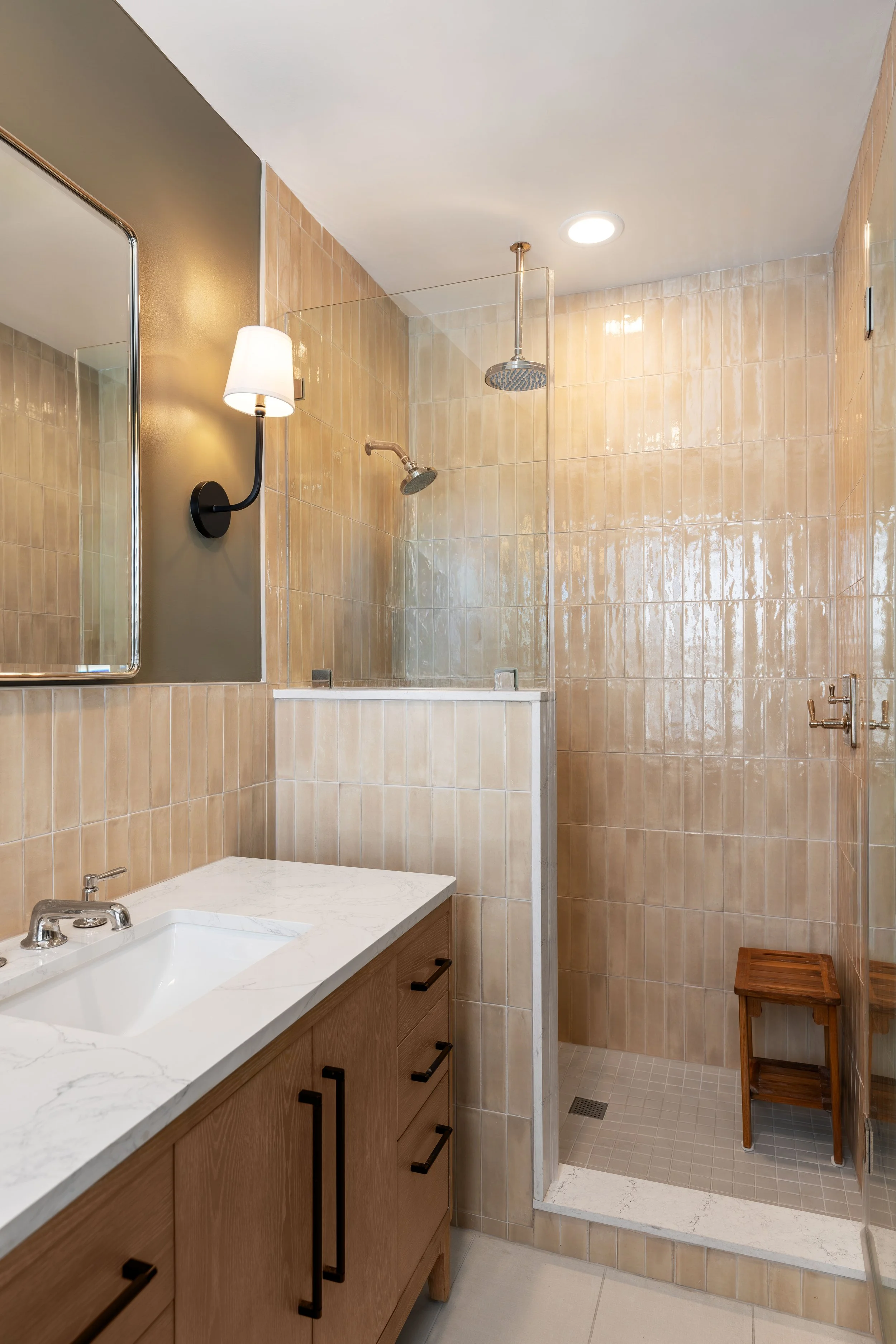 Primary bathroom renovation in a Washington, DC home with tiled walk-in shower, beige tiles, and chrome fixtures – Selis Studio Architecture.