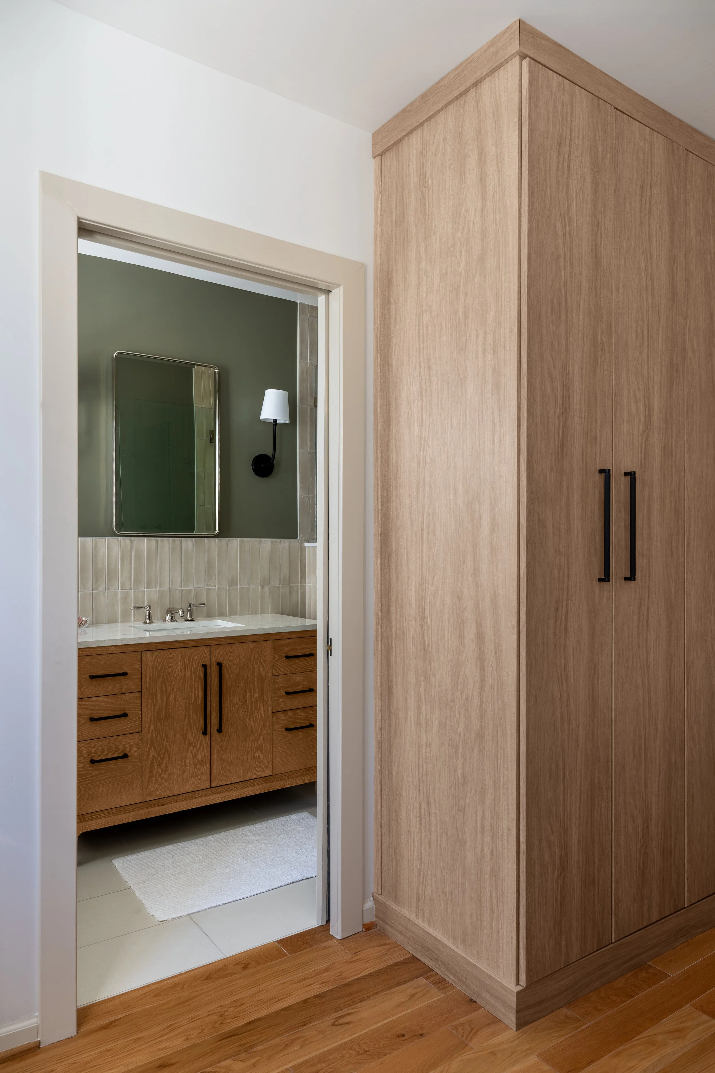 Modern rowhouse renovation in DC introducing custom storage solutions and updated finishes to the master bedroom and bathroom.